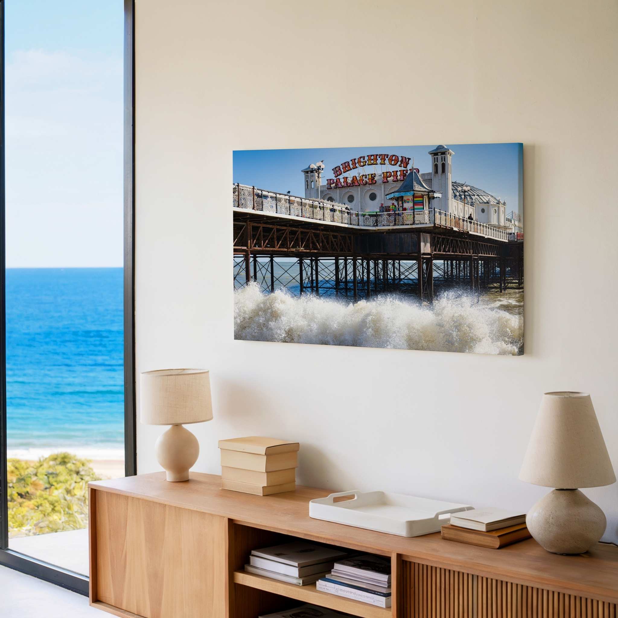 Brighton Palace Pier canvas wall art displayed above a light wood sideboard in a modern coastal living room featuring the iconic Victorian pier and crashing waves.