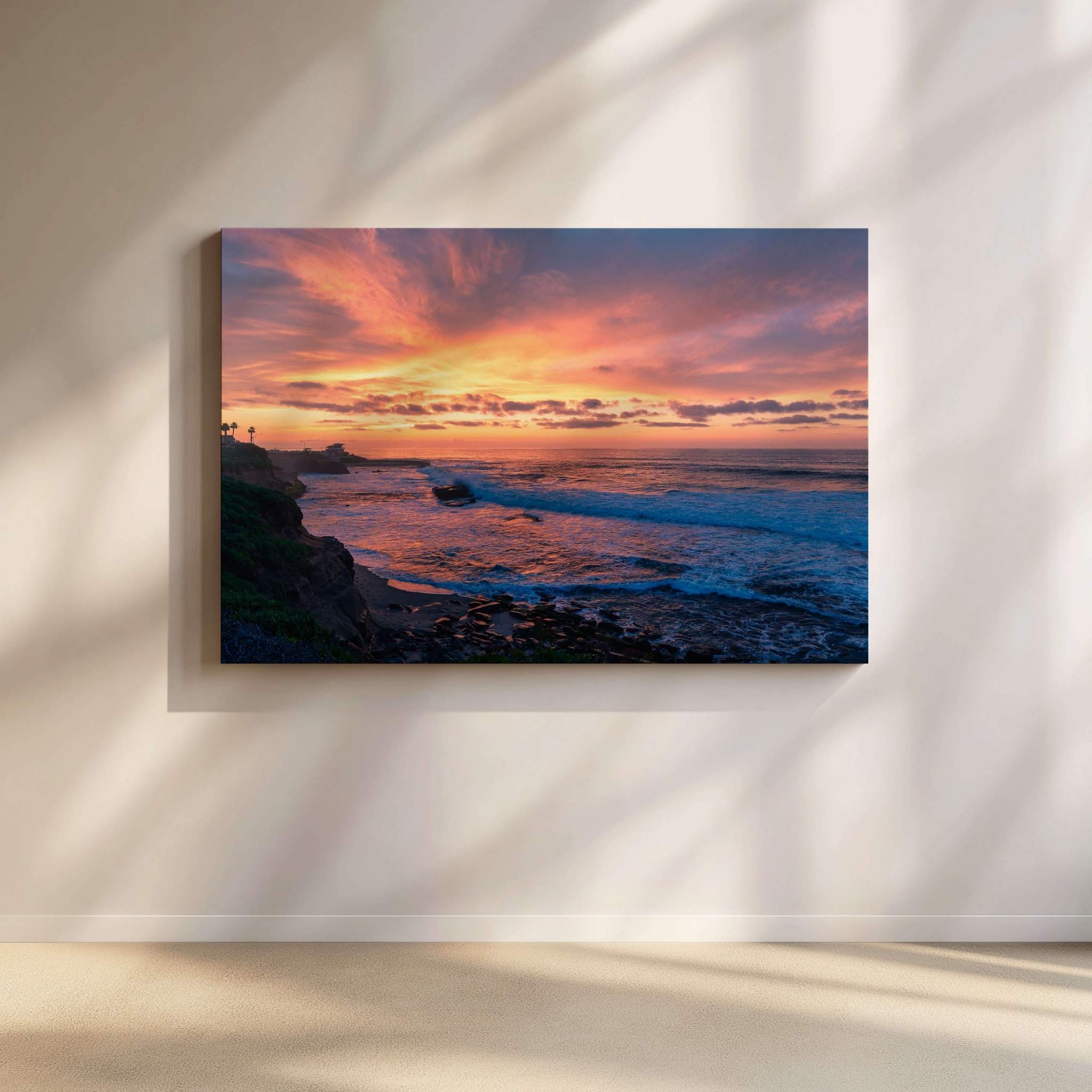 Candy Floss Sunset gallery-wrapped canvas by Abigail Diane Photography displayed in a contemporary minimalist living room, featuring a vibrant pink, orange, and purple sunset over the Pacific Ocean at La Jolla, San Diego, California.
