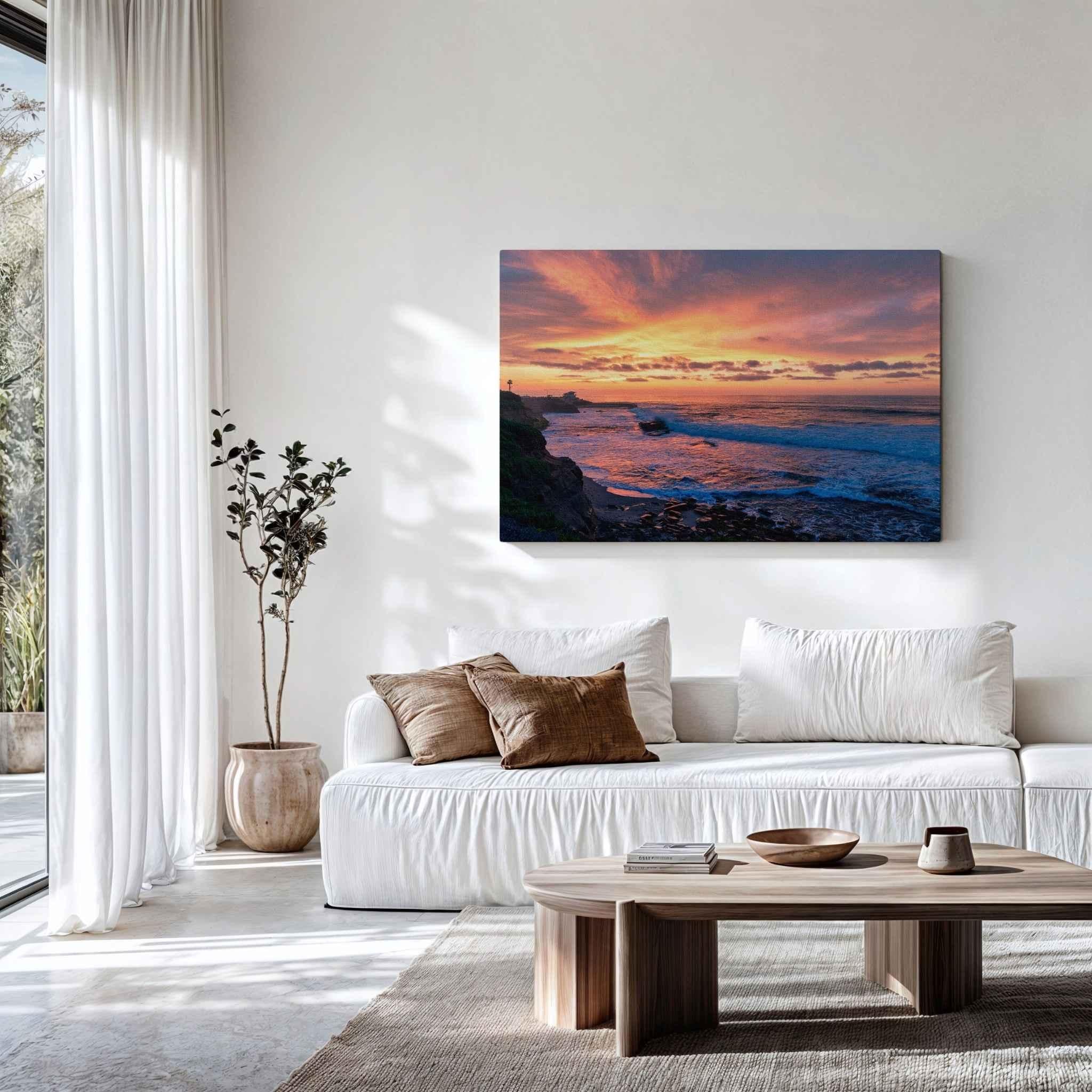 Large gallery-wrapped canvas of Candy Floss Sunset displayed above a white sofa in a bright contemporary living room, showcasing soft pink, peach, lavender, and golden skies over the Pacific Ocean in La Jolla, California. Fine art coastal wall décor by Abigail Diane Photography.