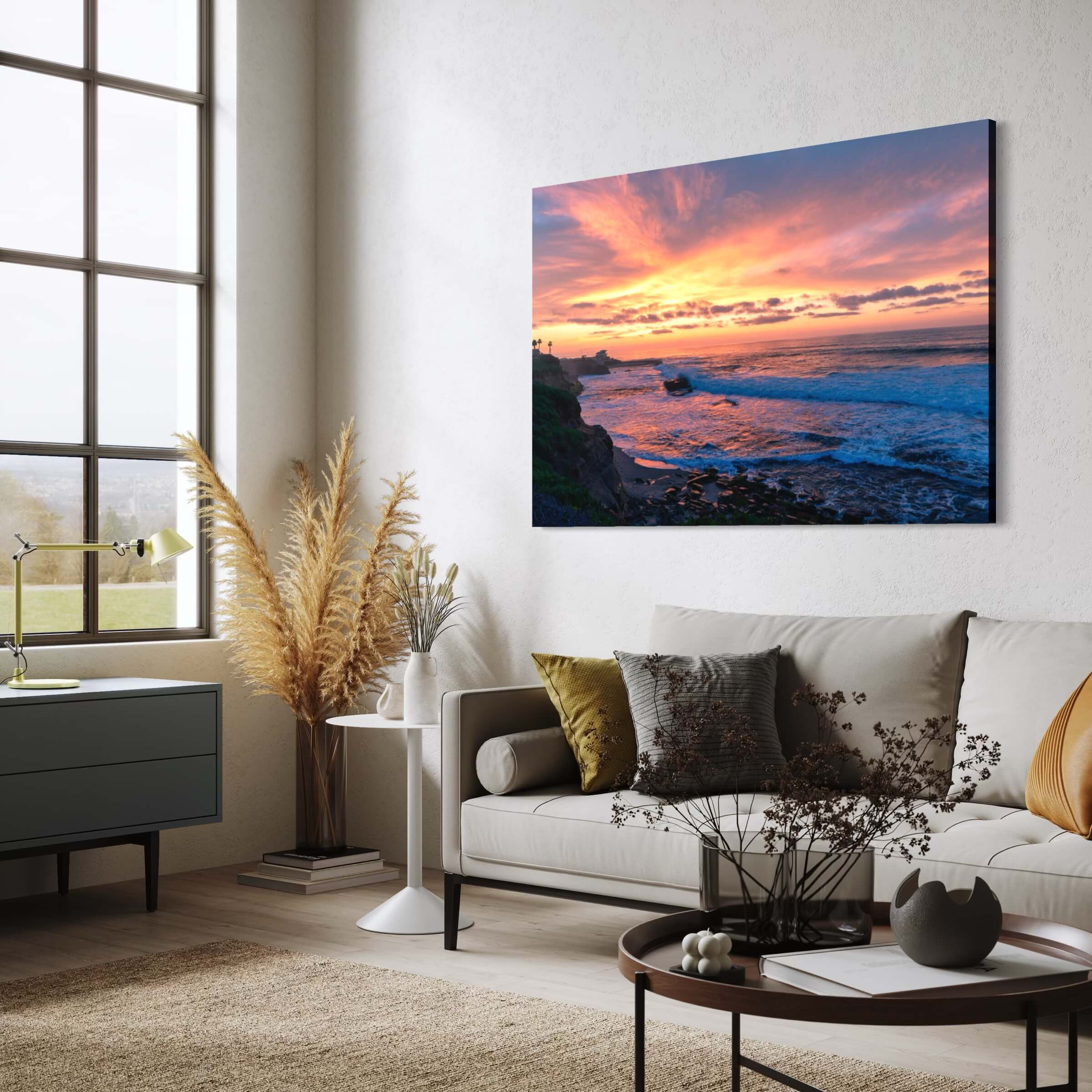 Candy Floss Sunset metal print displayed in a contemporary coastal living room, featuring pink and golden sunset clouds over the Pacific Ocean at Laguna Beach.
