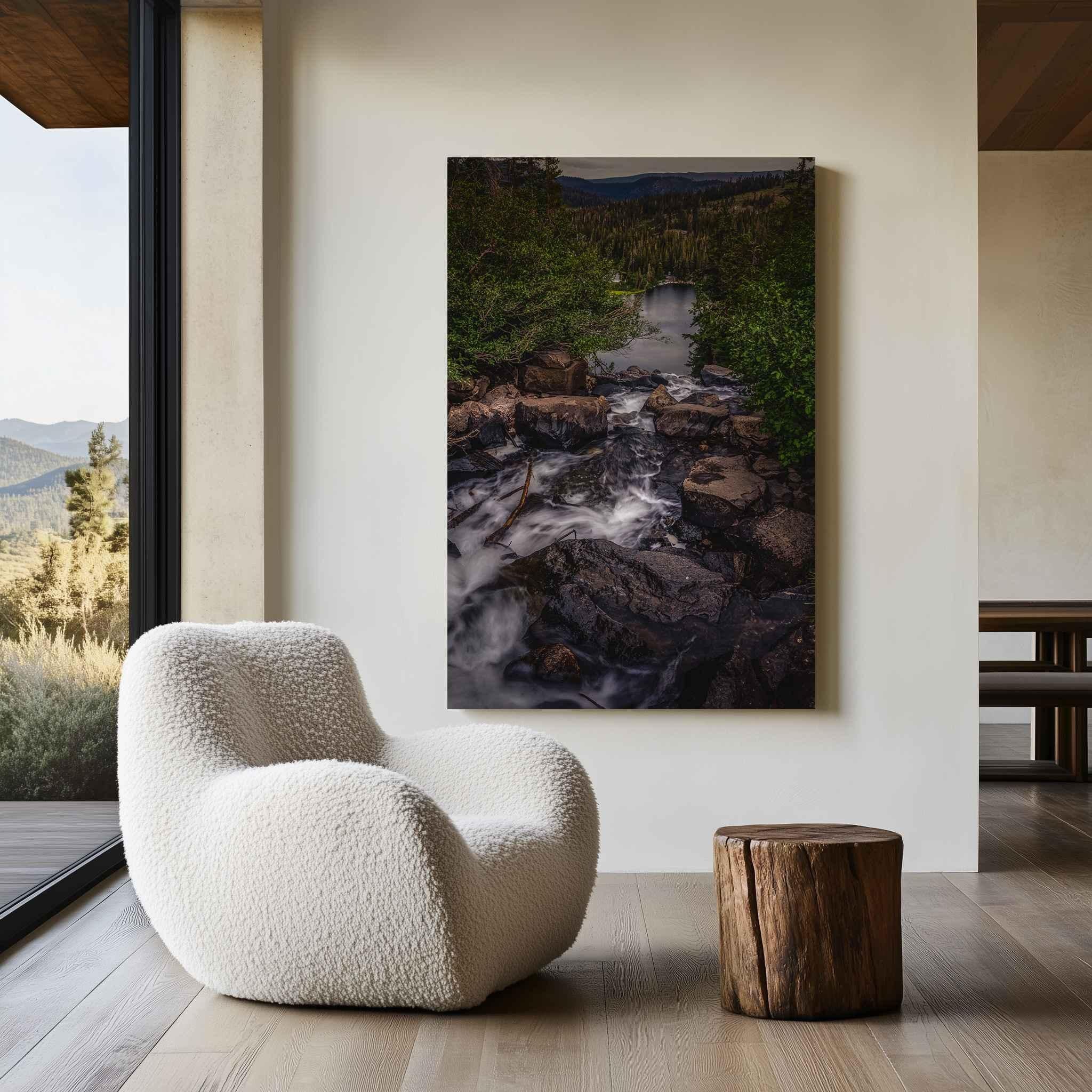 Cascading Into Stillness HD metal print featuring Twin Falls in Mammoth Lakes, California, displayed in a modern mountain-inspired interior with a white chair and wood accents