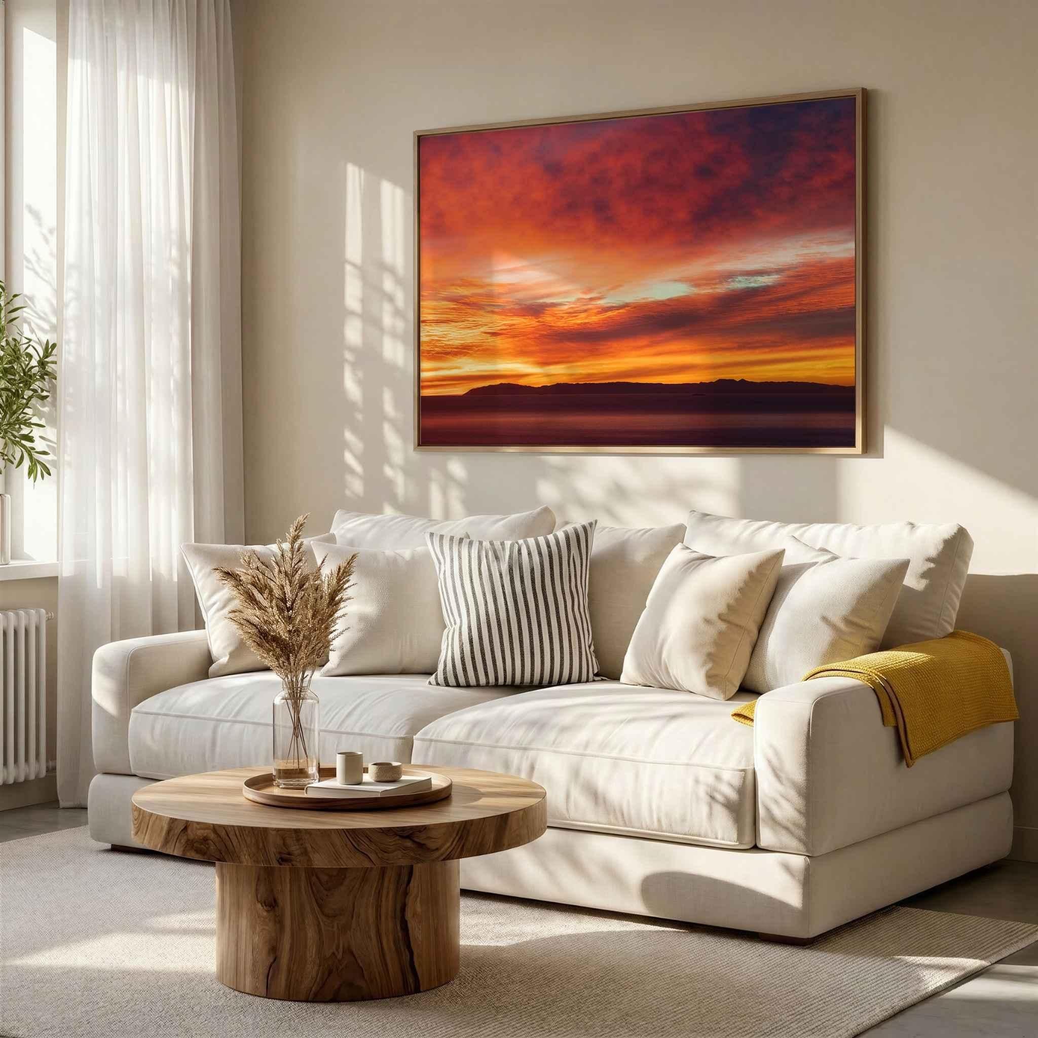 Large framed Catalina Beneath Crimson Skies fine art print displayed above a contemporary white sofa, showcasing a vibrant Southern California sunset over Catalina Island.