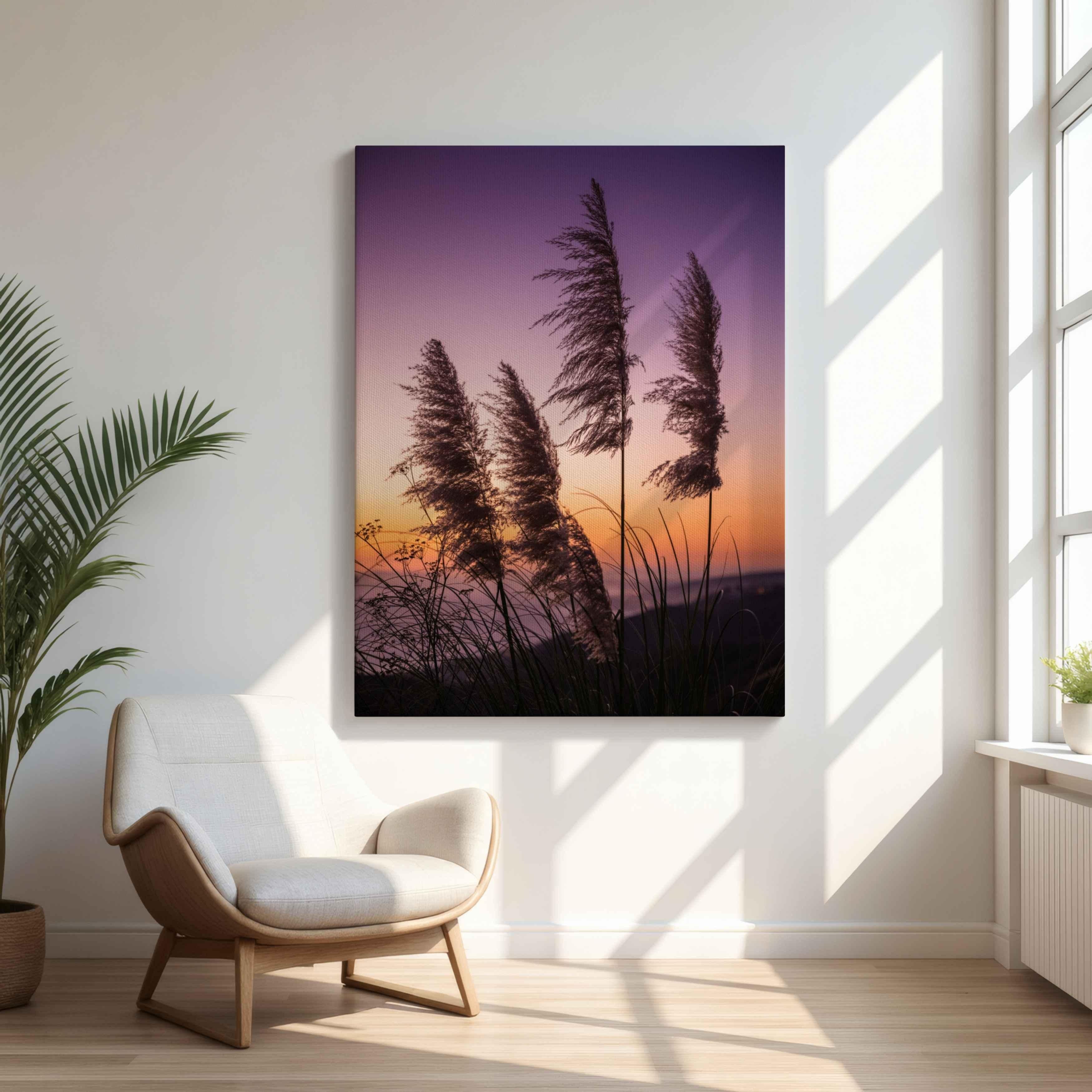 Modern Scandinavian living room featuring Abigail Diane Photography's Coastal Pampas Grass Sunset canvas print displayed above a sculptural cream lounge chair. Soft afternoon light streams through large windows. This peaceful coastal sunset gallery wrapped Canvas has silhouettes in lavender, blush, and golden hues creating a calming focal point for contemporary, minimalist, and coastal-inspired rooms.