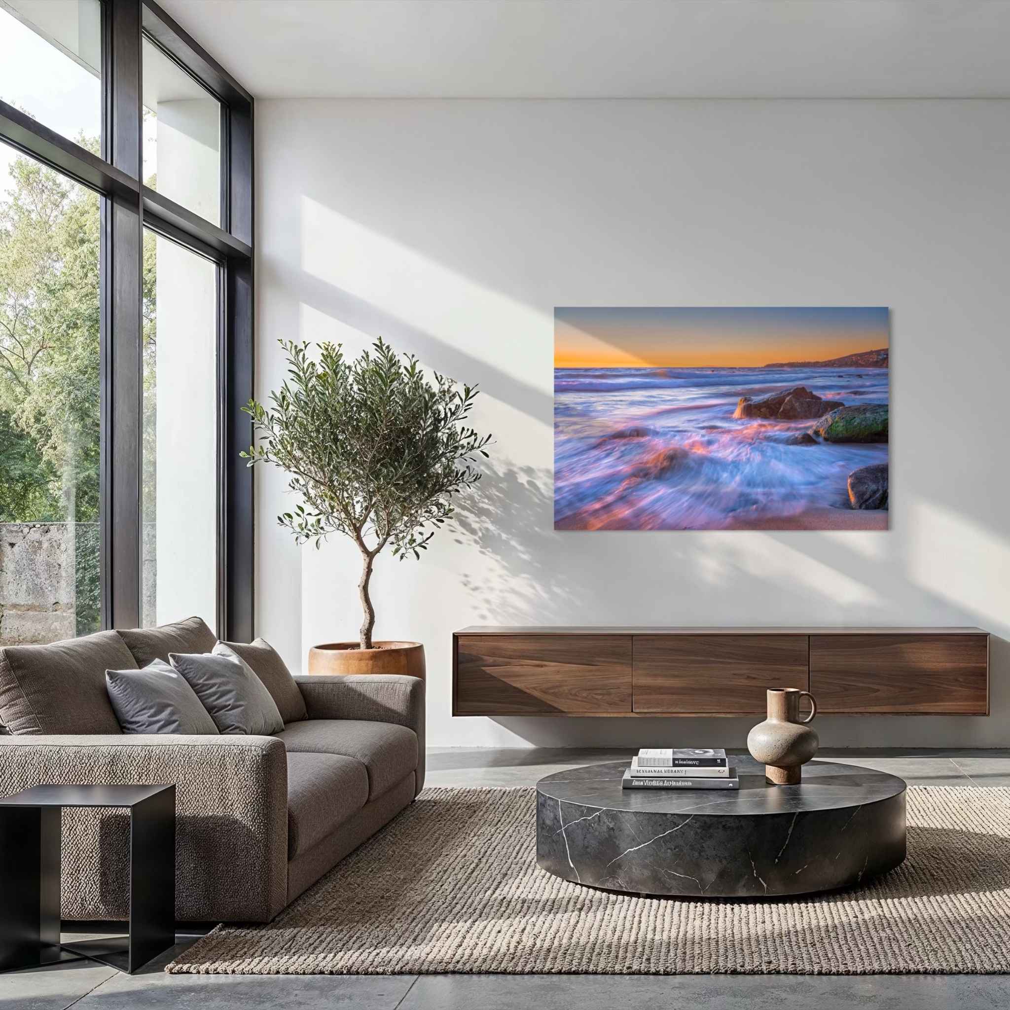Cotton Candy Waves dye-sublimation metal print by Abigail Diane Photography displayed above a contemporary sofa, highlighting pastel blue and pink ocean waves at sunset in Laguna Beach, California