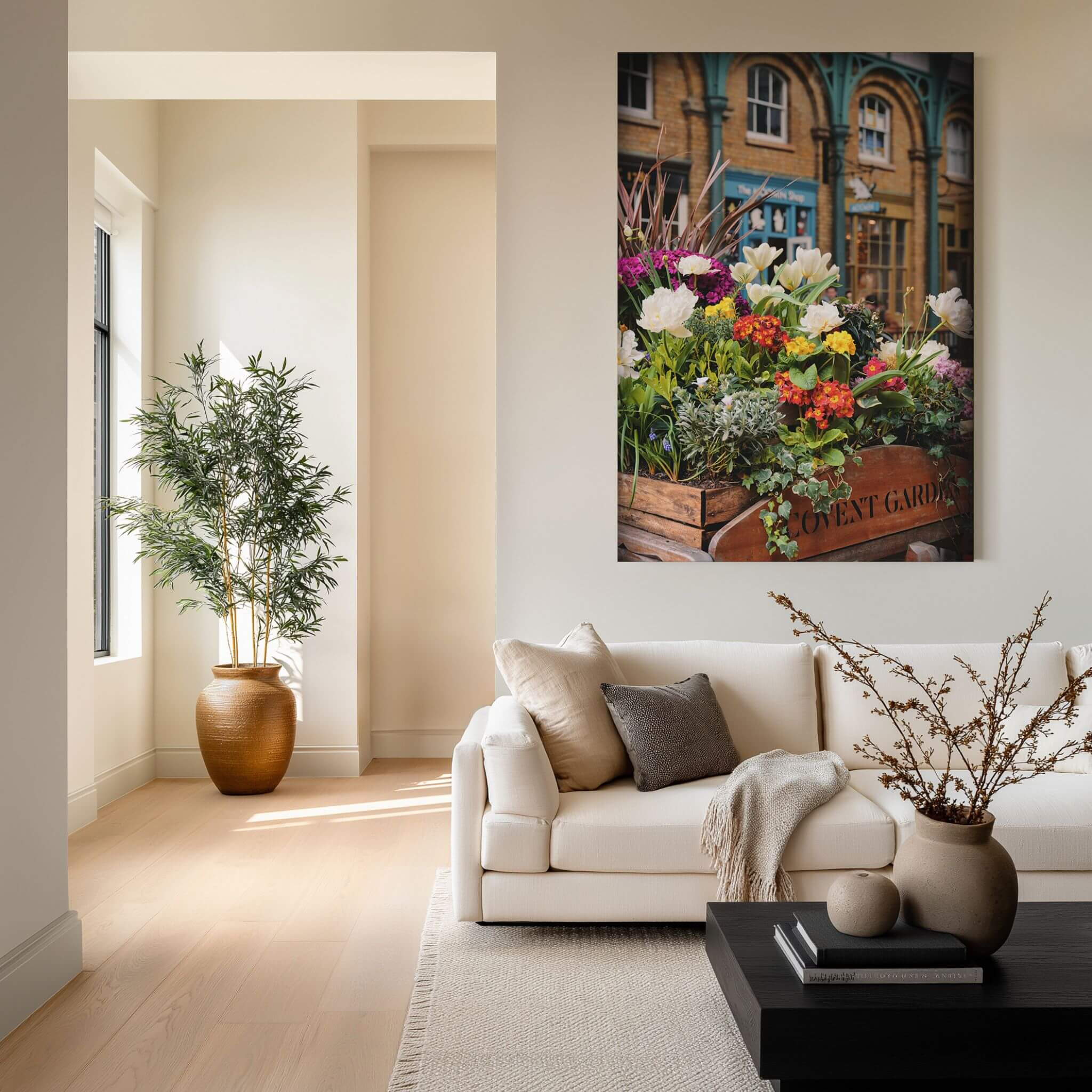 Covent Garden in Bloom fine art print displayed above a cream sofa in a warm neutral living room with natural wood and greenery.