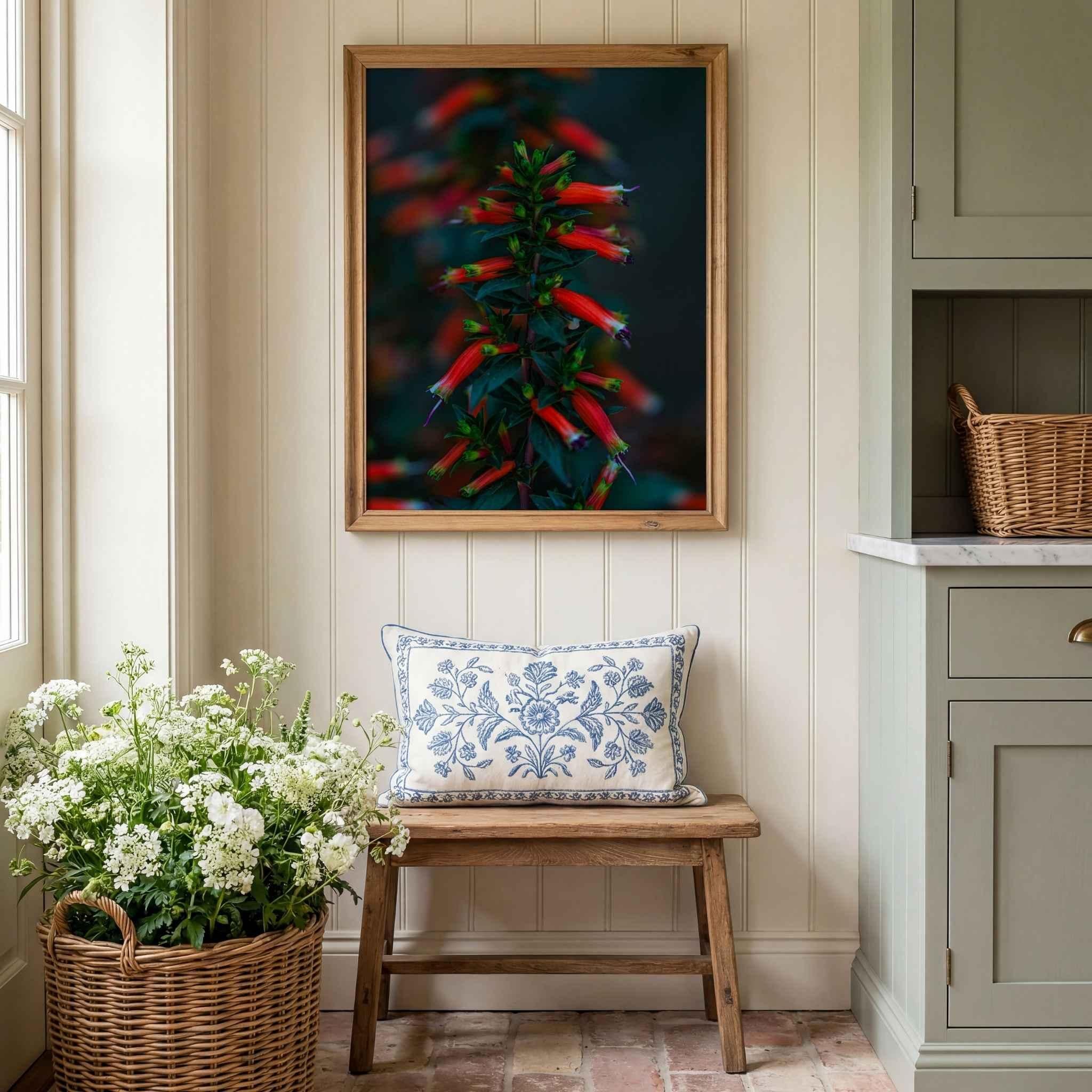 Crimson Whispers at Twilight framed botanical wall art displayed above a rustic wooden bench in a cottage-style entryway with woven basket, fresh white flowers, and sage green cabinetry.