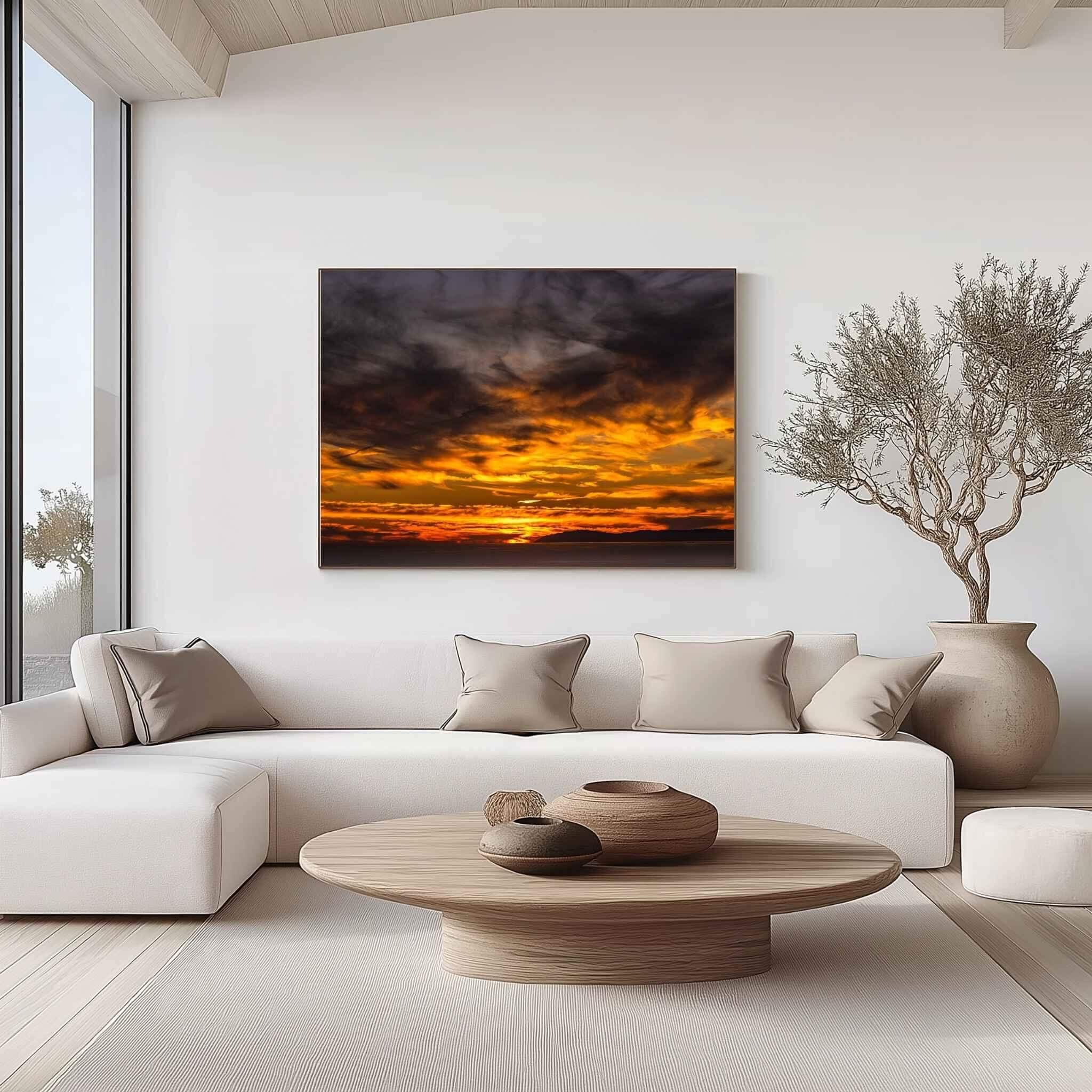 Large gallery-wrapped canvas print of Gleaming Golden Sunset over Laguna Beach, California by Abigail Diane Photography displayed above a contemporary cream sofa in a bright modern living room with warm neutral décor.
