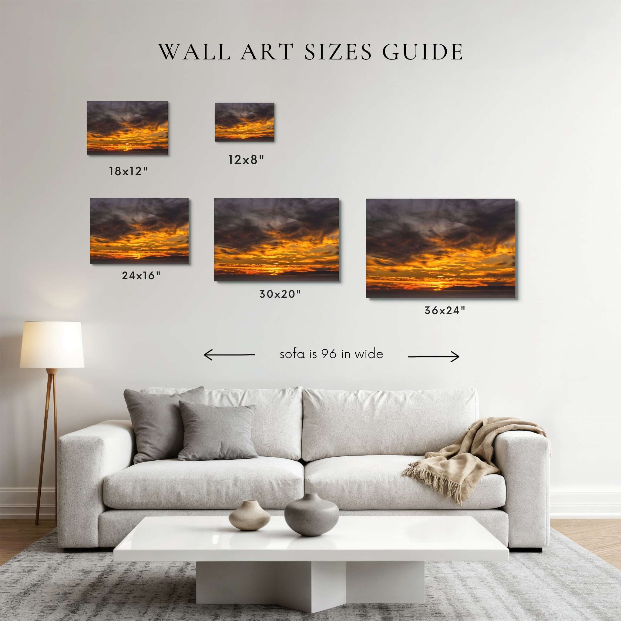 A wall art sizes guide mockup showing five sunset canvas prints above a light gray sofa in a living room. The prints are labeled 18x12", 12x8", 24x16", 30x20", and 36x24", with text indicating sofa width is 96 in wide.