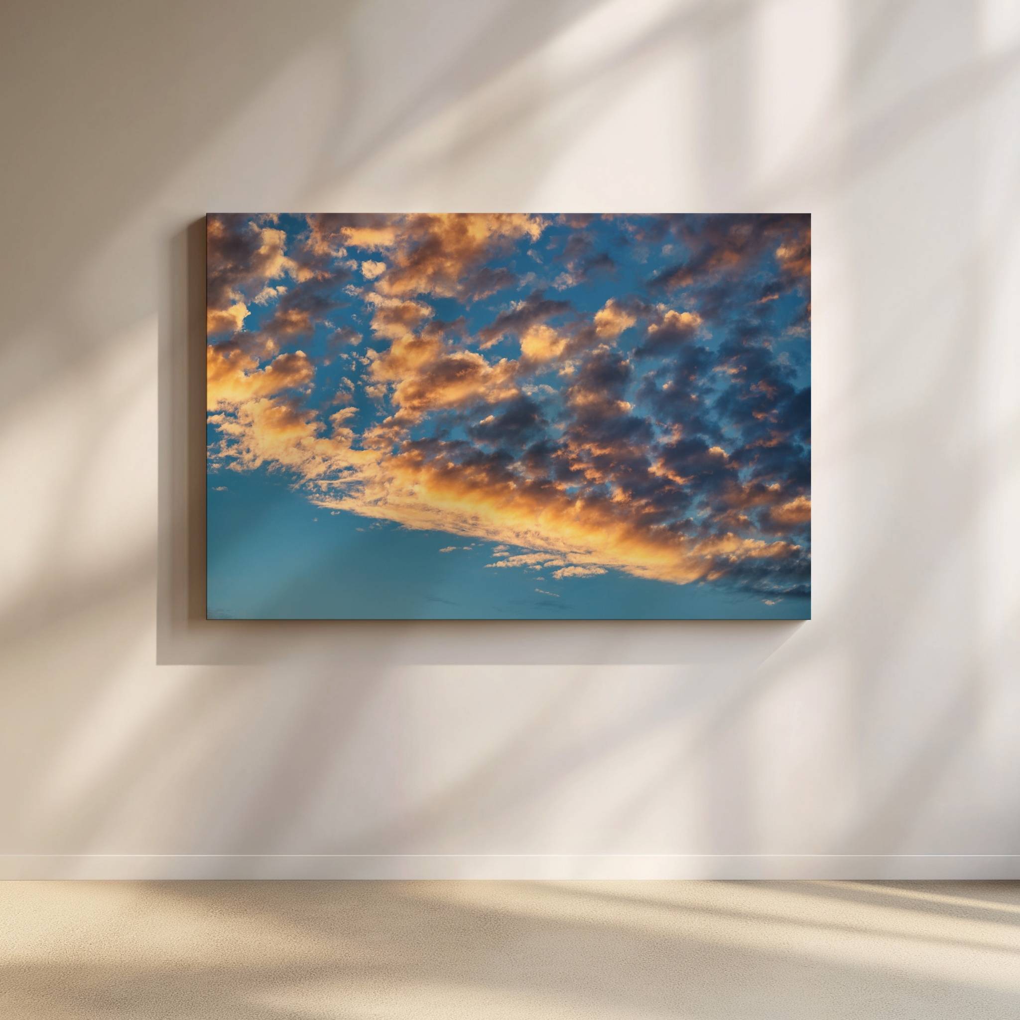 Gold and Blue Symphony of the Sky captures glowing golden clouds drifting across a deep blue evening sky, creating a dramatic cloudscape. Fine art cloudscape wall art by Abigail Diane Photography.