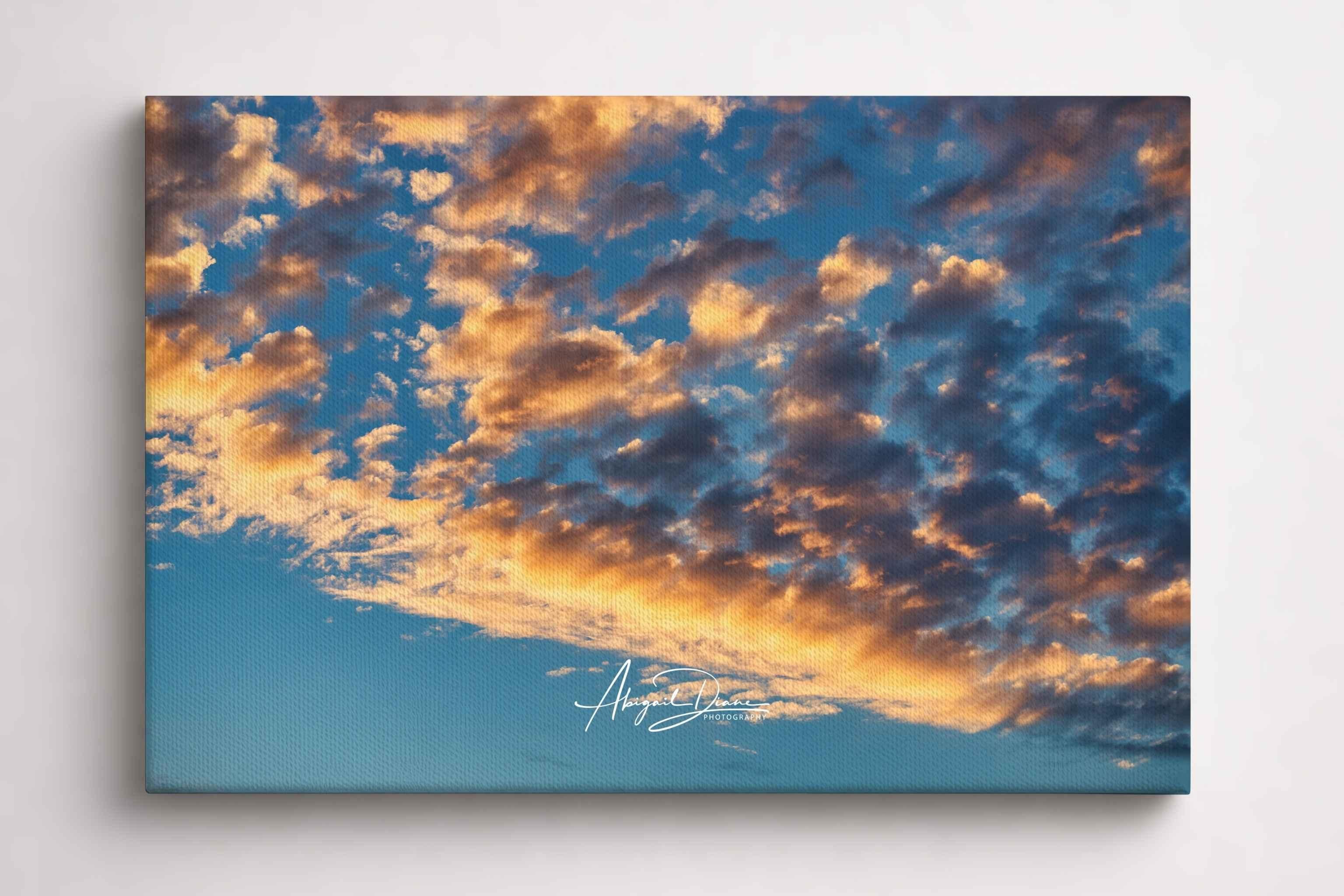 Gold and Blue Symphony of the Sky featuring golden hour clouds illuminated against a deep blue sky. Fine art cloudscape photography by Abigail Diane Photography.