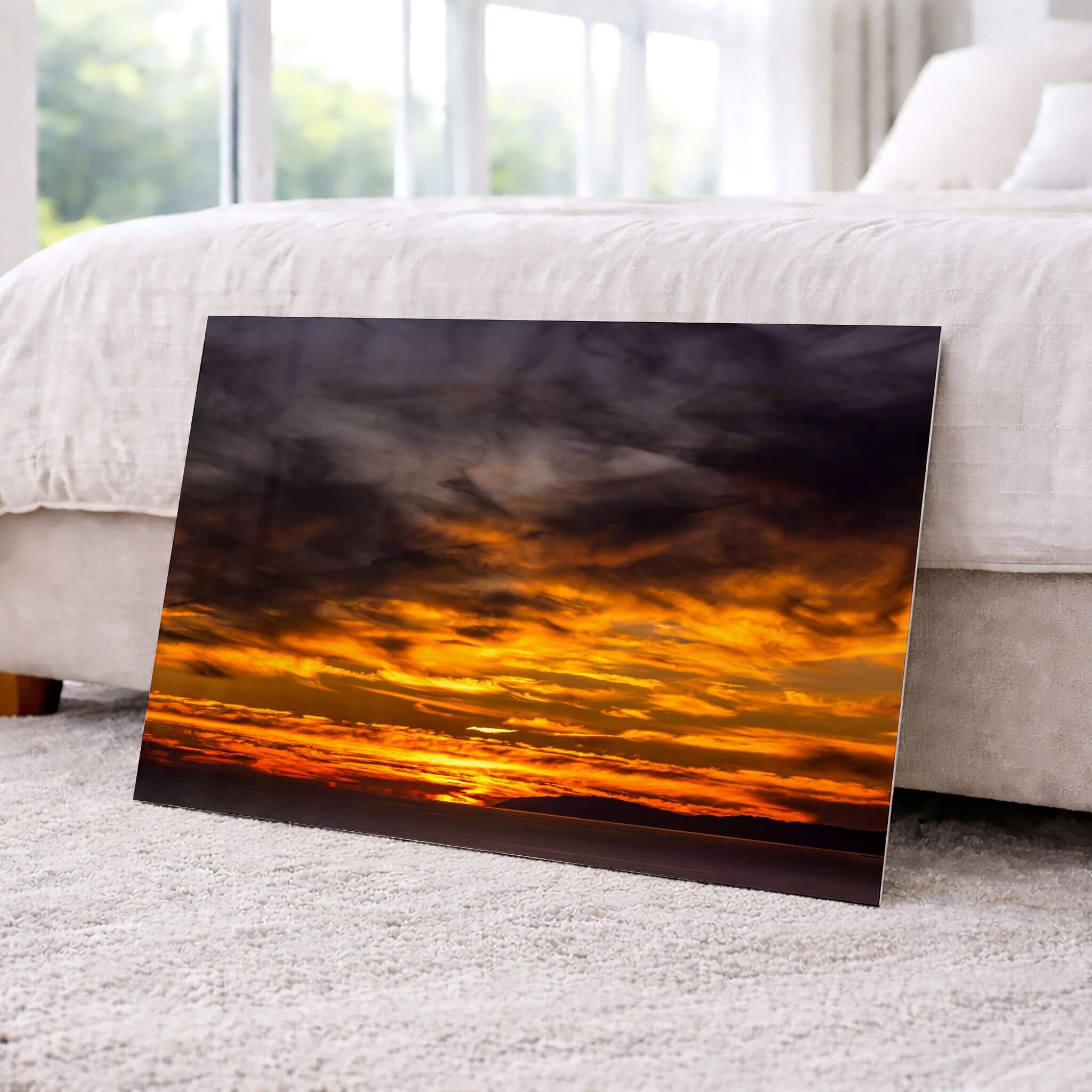 Golden Gleaming Sunset Laguna Beach sunset HD metal print displayed beside a contemporary bed, adding warm golden light and dramatic coastal skies to the room.