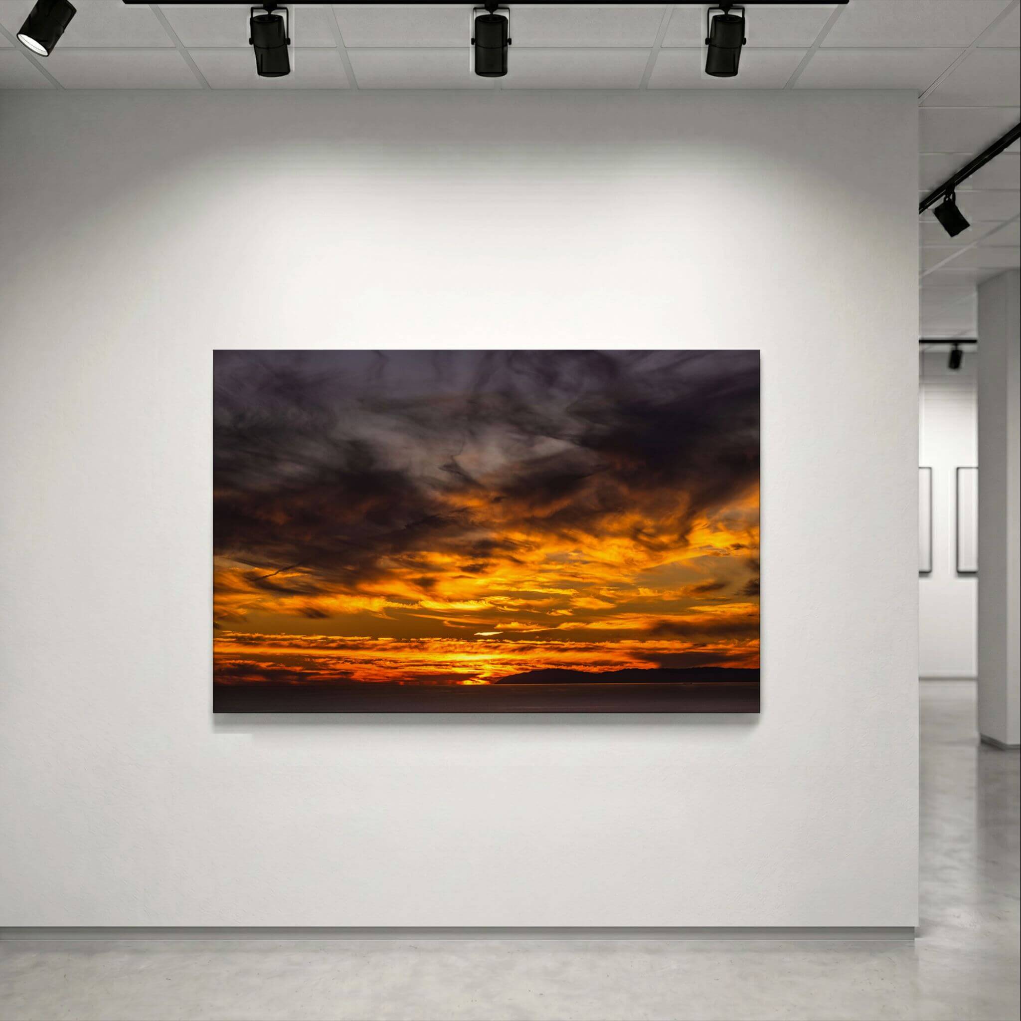 Golden Gleaming Sunset Laguna Beach sunset HD metal wall art displayed in a contemporary gallery, showcasing dramatic golden clouds over the Pacific Ocean.