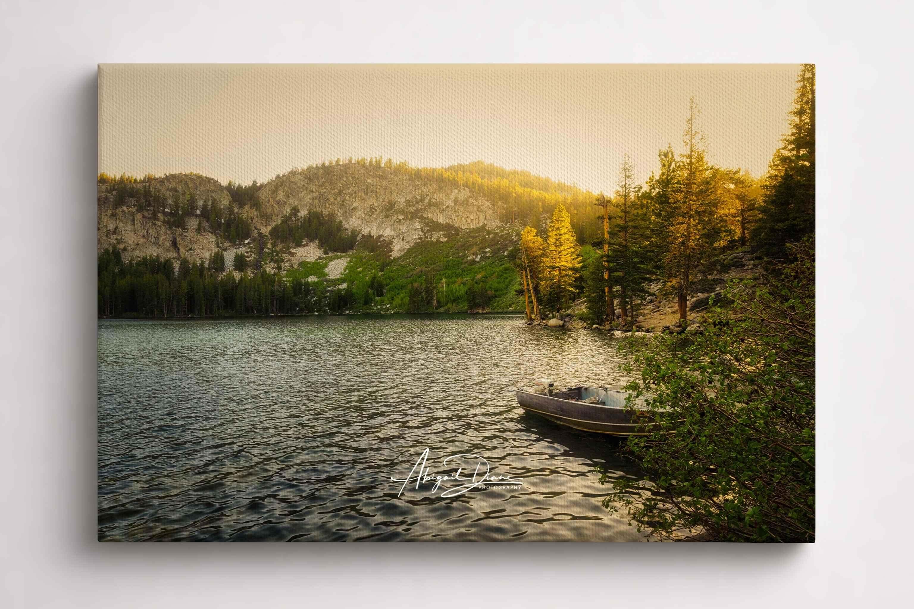 Golden Hour Alpine Lake landscape with a small boat resting along the shoreline, surrounded by pine-covered mountains in Mammoth Lakes, Eastern Sierra, California, displayed as a gallery-wrapped canvas print.