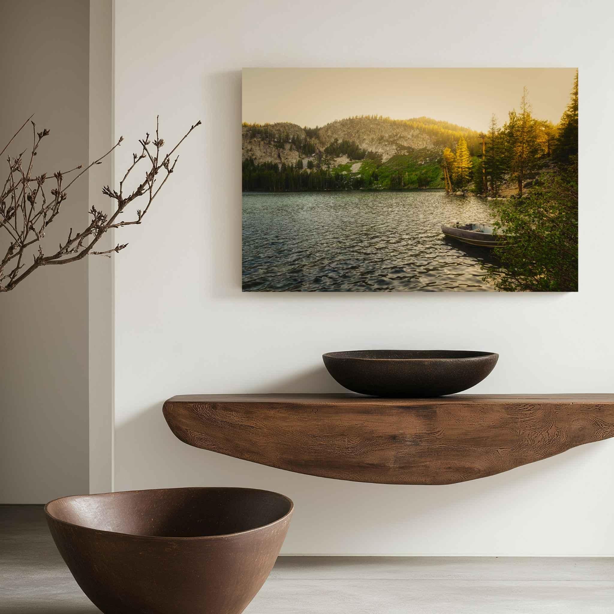 Golden Hour Alpine Lake metal print displayed above a sculptural wood console in a minimalist neutral interior with warm natural tones