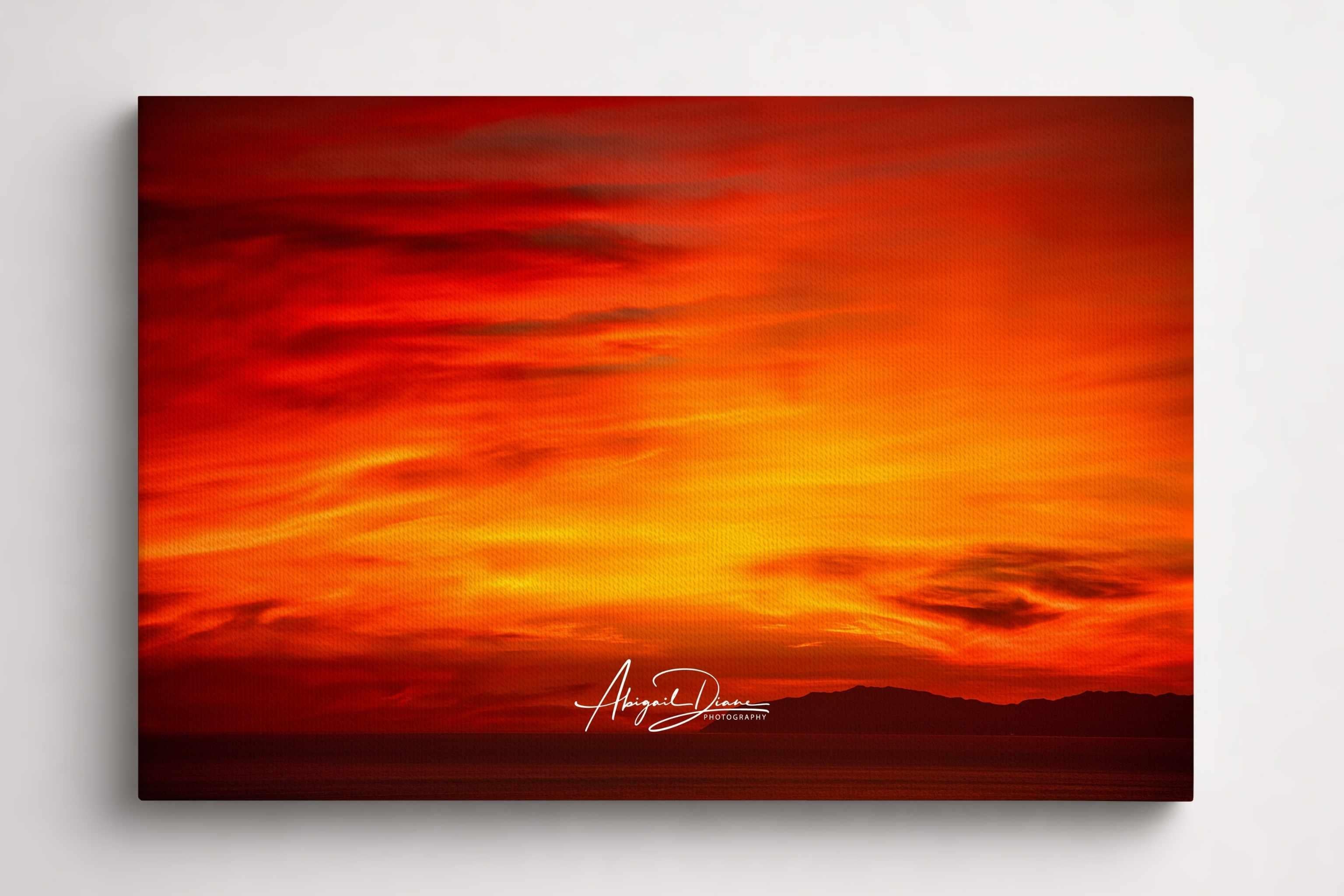 Inferno Sunset captures fiery crimson, orange, and golden skies above Catalina Island in the Pacific Ocean at sunset. Fine art canvas print by Abigail Diane Photography.