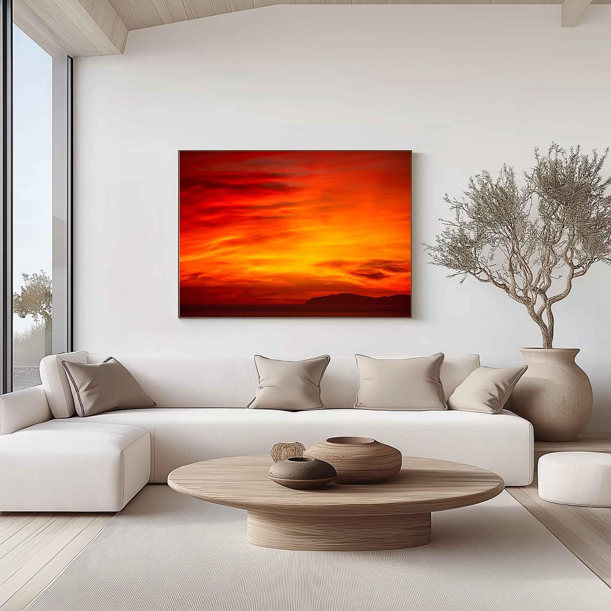 Large gallery-wrapped canvas of Inferno Sunset displayed above a contemporary cream sofa in a minimalist living room, showcasing vibrant crimson, orange, and gold skies over Catalina Island. Fine art wall décor by Abigail Diane Photography.