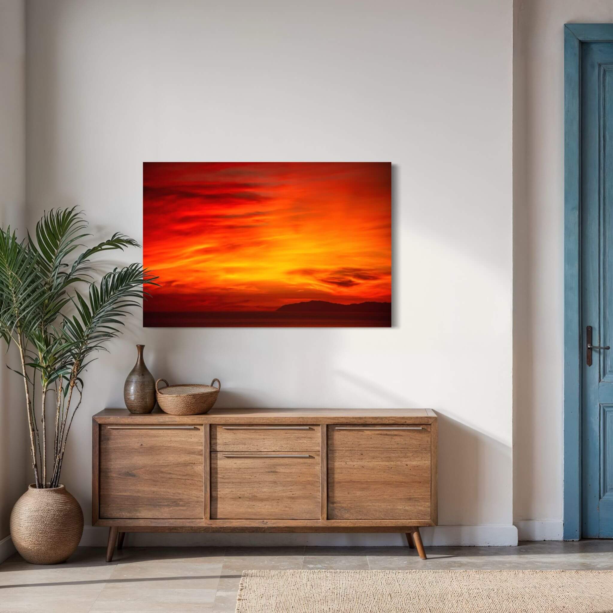 Inferno Sunset Catalina Island metal wall art displayed above a natural wood console in a warm contemporary interior. Artwork by Abigail Diane Photography.