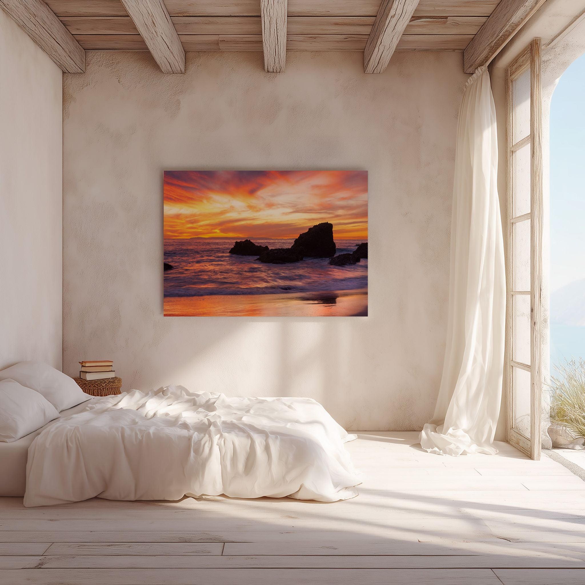 Peaceful bedroom featuring high definition metal wall art of Woods Cove Beach, Laguna Beach, California, with glowing sunset skies, ocean waves, and coastal rocks by Abigail Diane Photography.