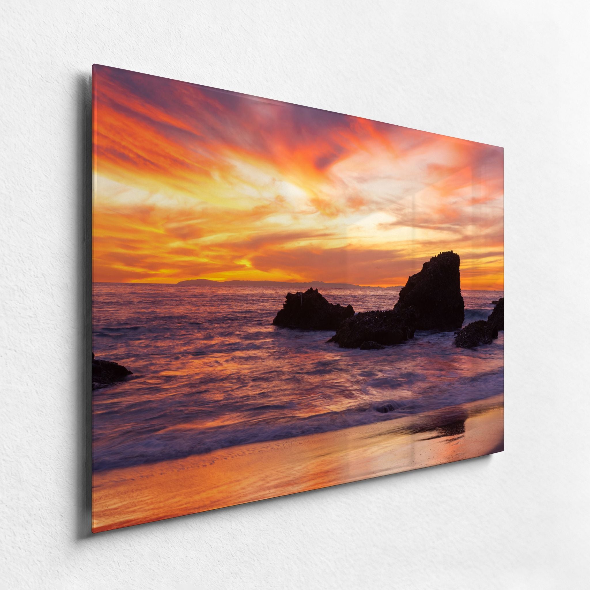 Close-up of a premium high definition metal wall art print featuring Woods Cove Beach at sunset in Laguna Beach, California, with glowing orange skies, coastal rocks, and ocean reflections by Abigail Diane Photography.