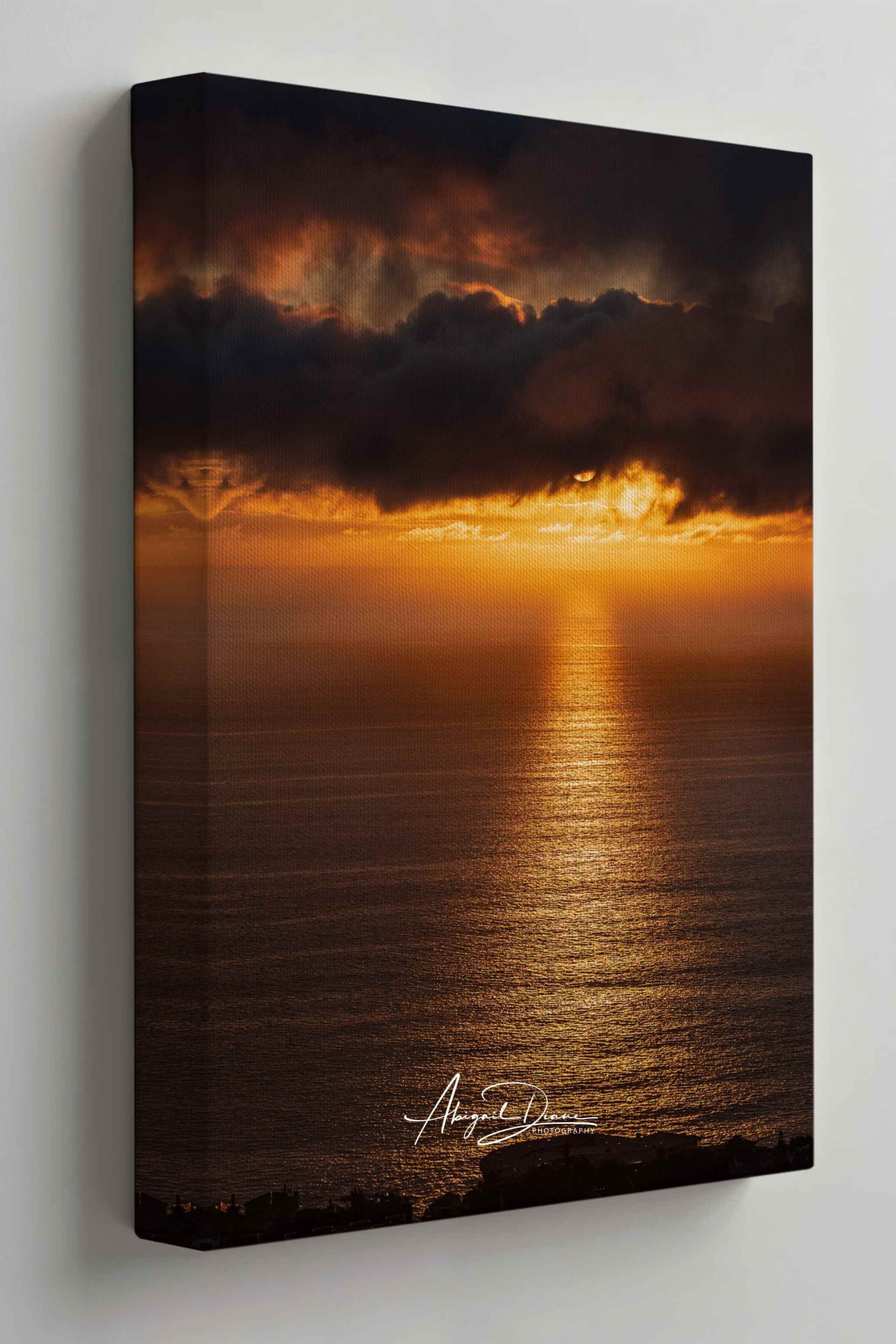 Close-up of Abigail Diane Photography's Laguna Beach Winter Sunset wrapped canvas print showcasing gallery-wrapped edges and premium canvas texture. This fine art coastal landscape captures dramatic winter storm clouds, glowing golden sunlight reflecting across the Pacific Ocean, and rich amber tones, highlighting the craftsmanship and depth of a museum-quality canvas ready to hang in modern, coastal, or contemporary interiors.