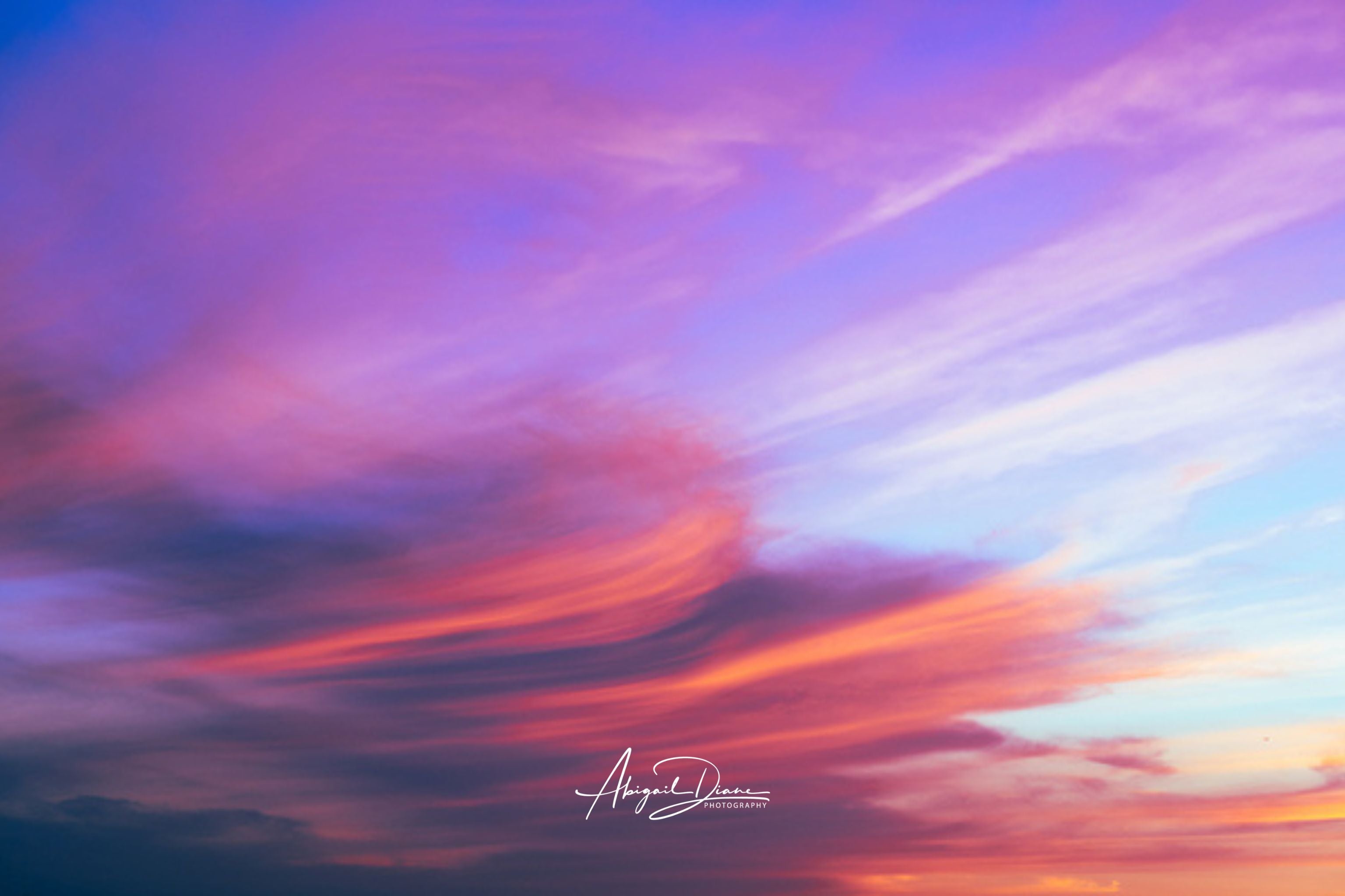  Lavender Dreams captures delicate lavender, blush pink, and soft blue clouds sweeping across the evening sky, creating a tranquil cloudscape sunset. Fine art  print by Abigail Diane Photography.