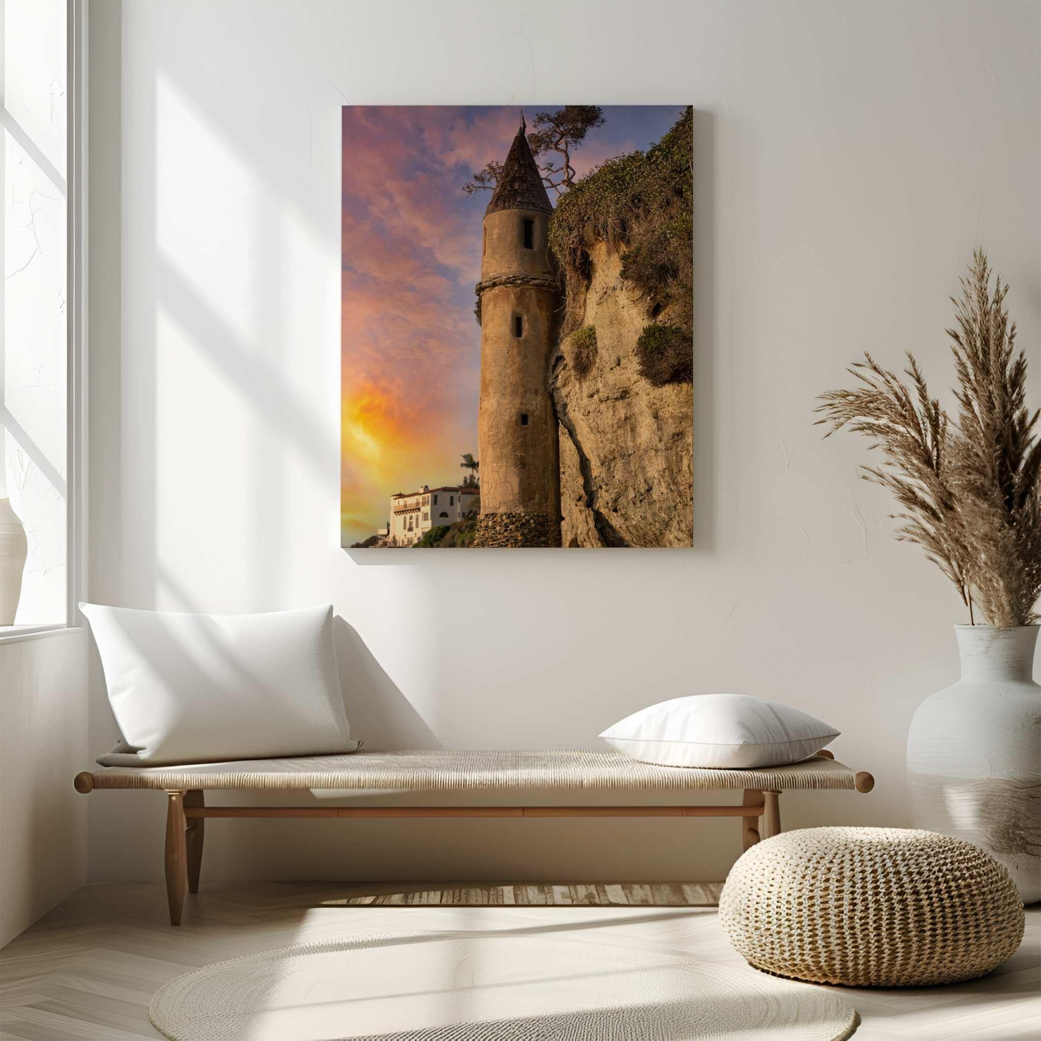 Large ChromaLuxe HD Metal Print of Let Your Hair Down by Abigail Diane Photography displayed above a woven bench in a bright contemporary interior, featuring the Victoria Beach Pirate Tower at sunset in Laguna Beach, California