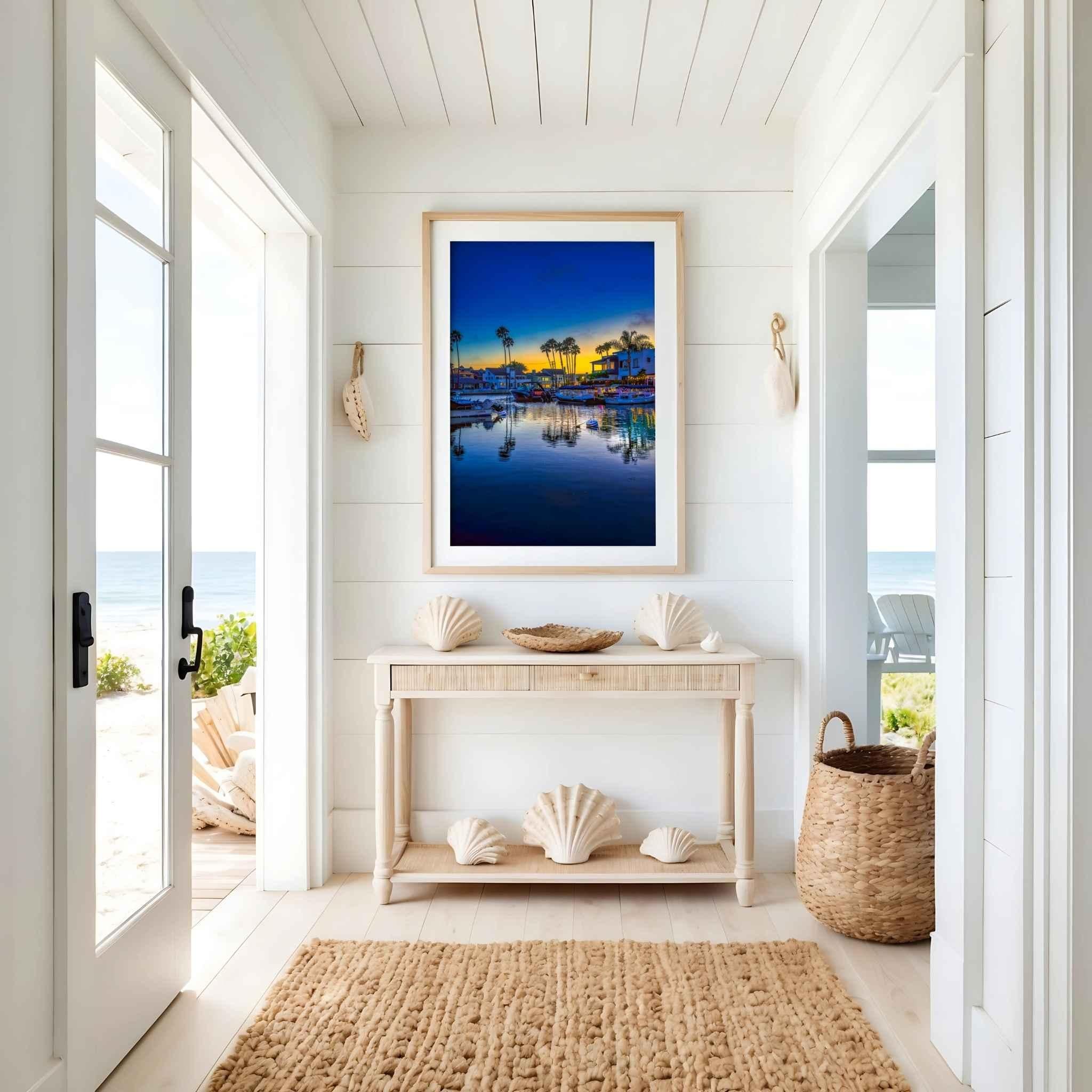 Magic of the Blue Hour by Abigail Diane Photography displayed as a framed fine art print in a bright coastal entryway with natural oak frame, beach-inspired décor, and ocean views.