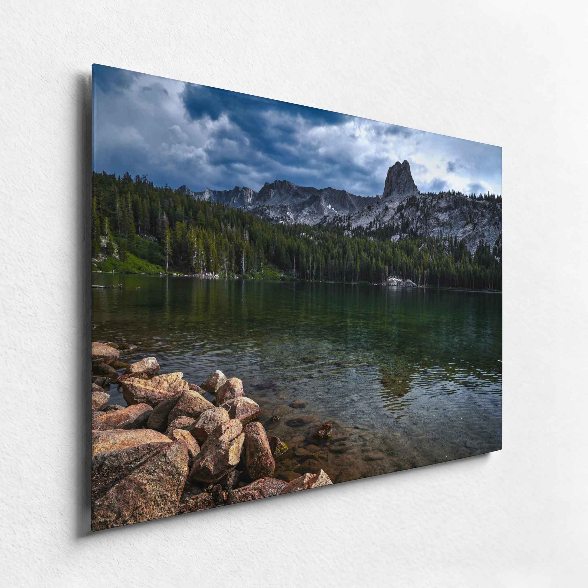 Lake Mary in the Eastern Sierras mountain lake beneath dramatic clouds and rugged peaks, displayed as an HD metal print from an angled side view.