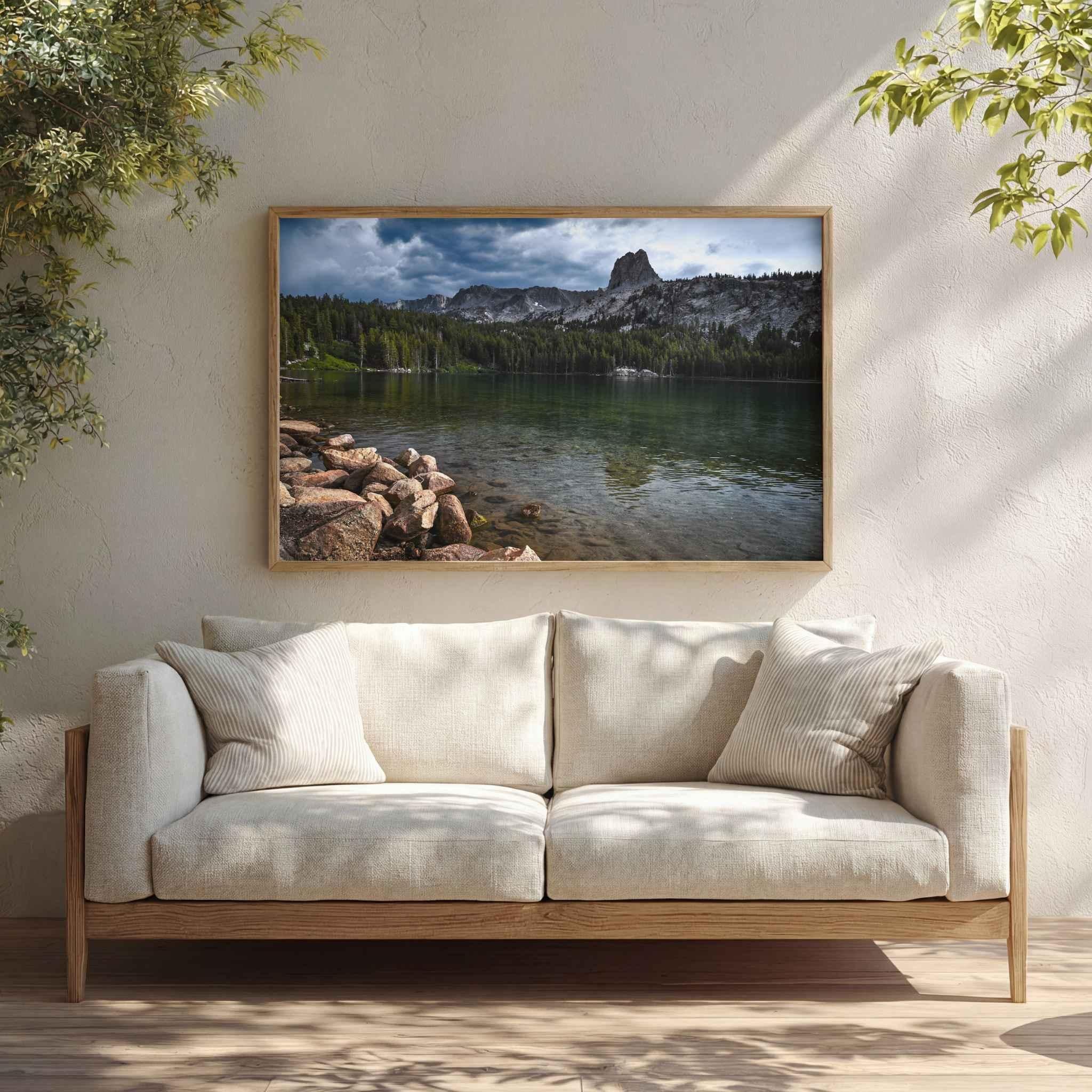 Reflections on Lake Mary fine art print displayed in a bright neutral living room above a cream sofa with natural wood frame.