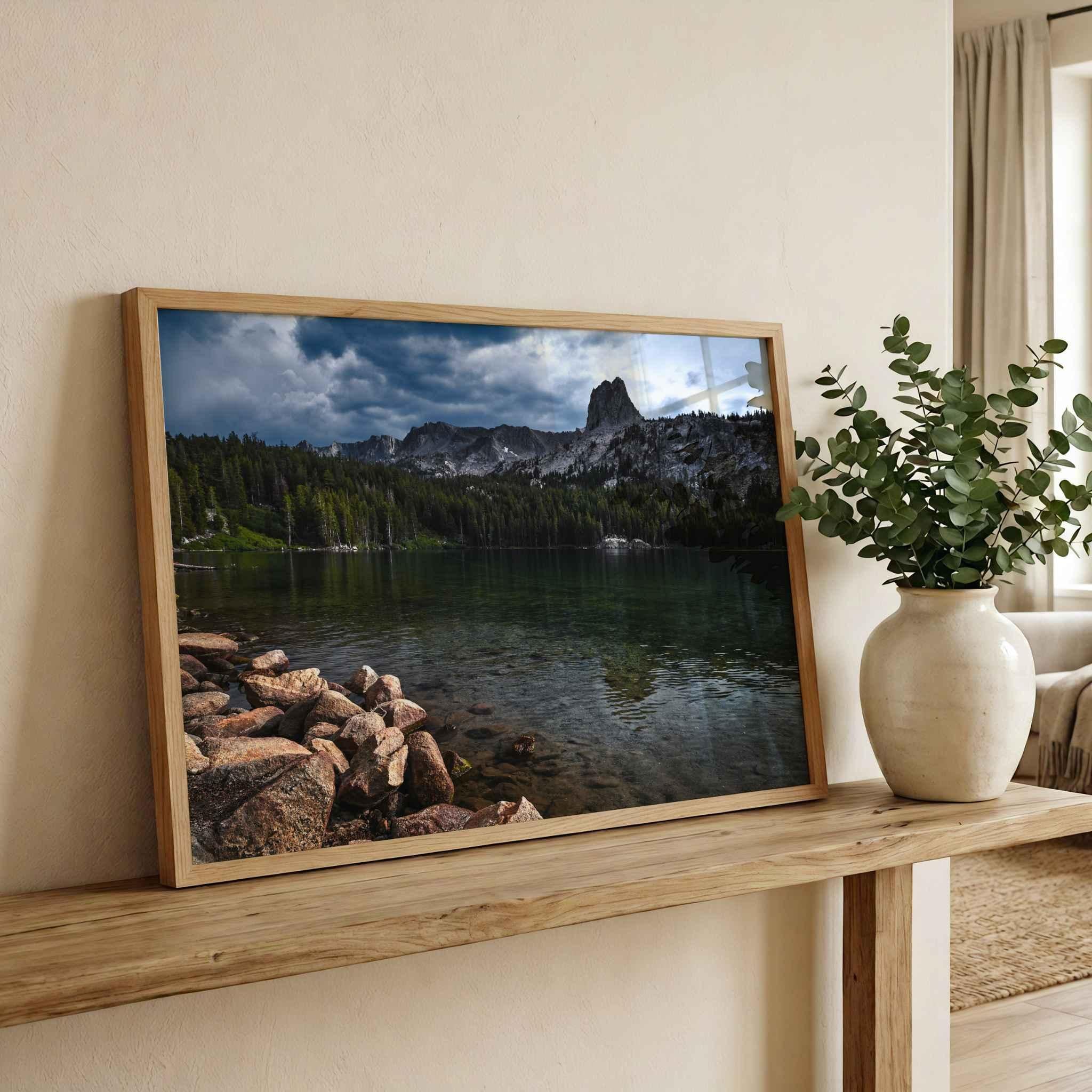 Reflections on Lake Mary framed fine art print in a natural wood frame displayed on a console in a warm neutral interior.