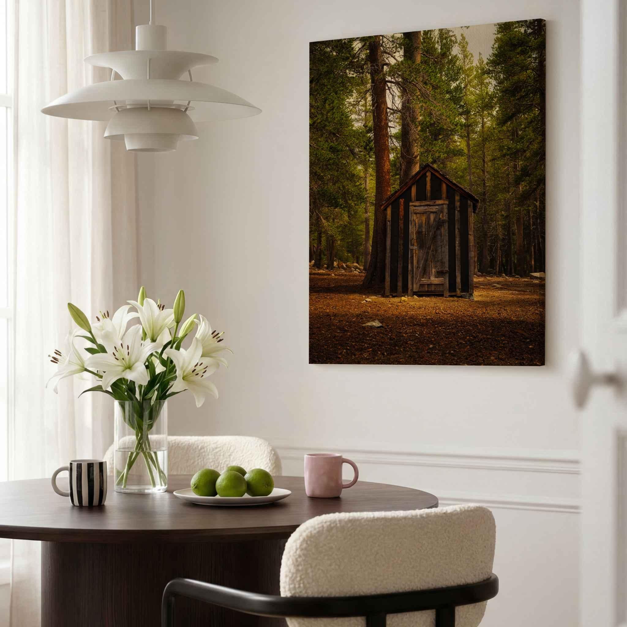 Rustic Remnant Among the Trees canvas print featuring an old wooden outhouse in the Eastern Sierra displayed in a modern dining room.