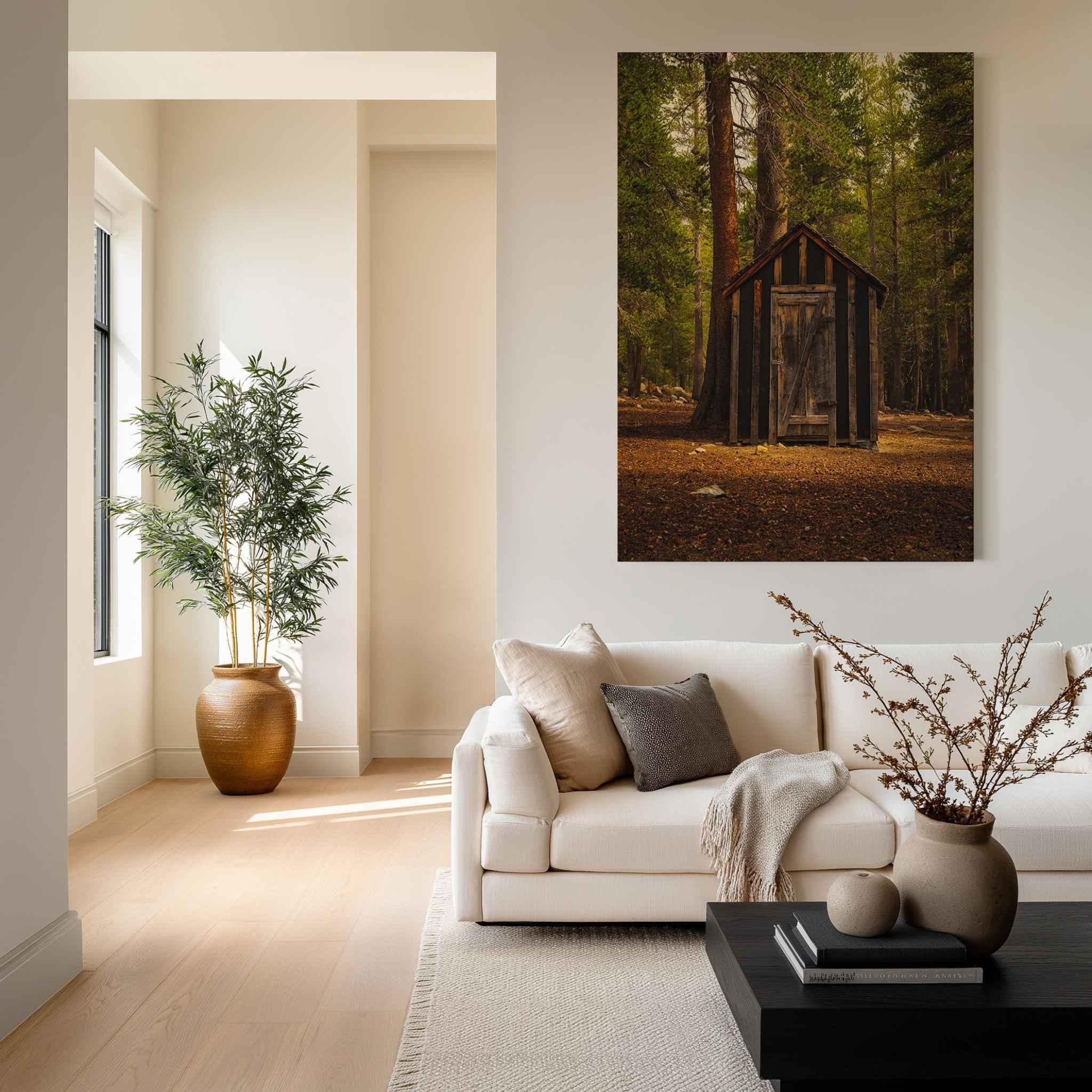 Remnant Among the Trees metal print featuring a historic wooden cabin in a Mammoth Lakes California forest, displayed in a warm modern living room.