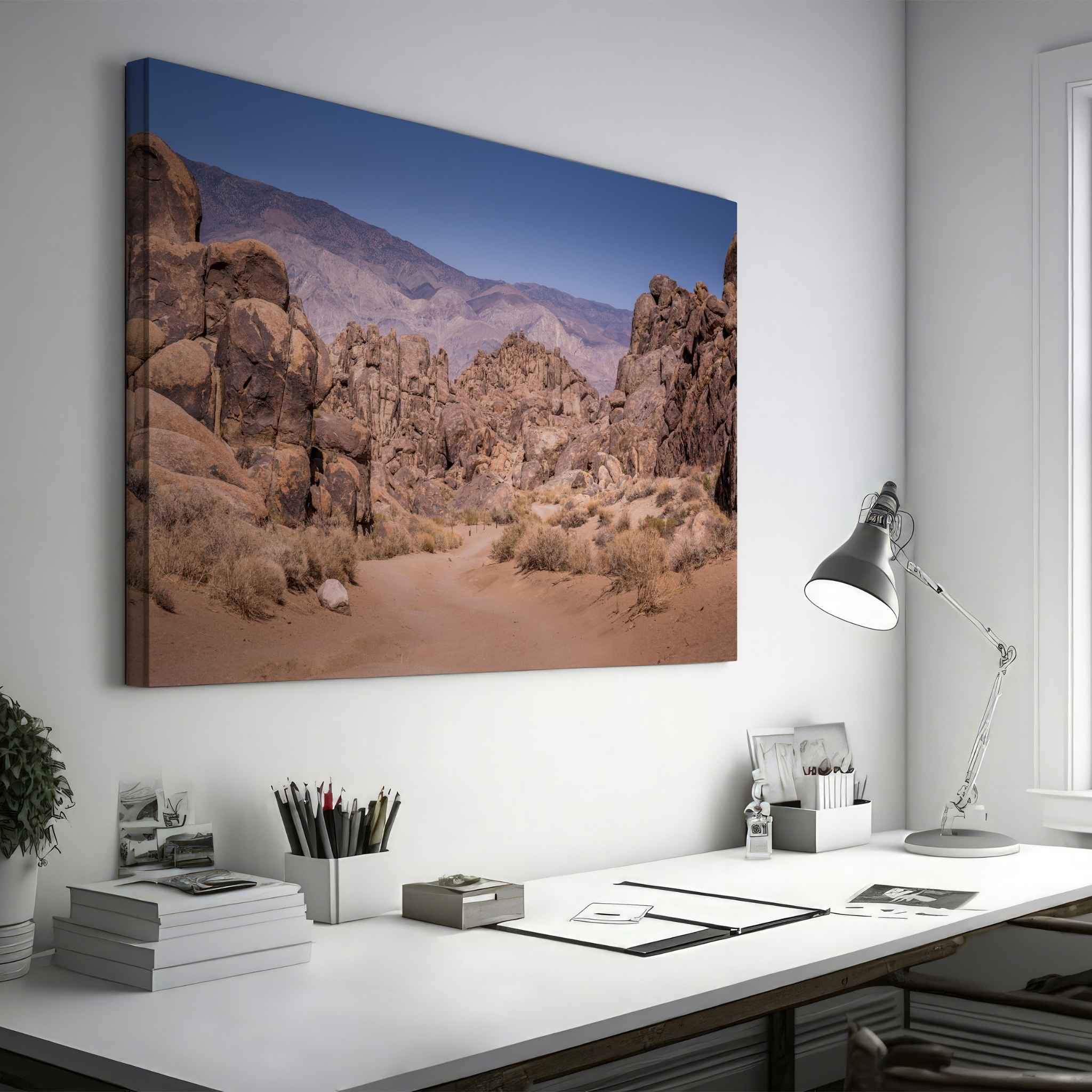 Sierra Desert Passage canvas print of the Alabama Hills near Lone Pine, California, displayed above a desk in a modern home office.