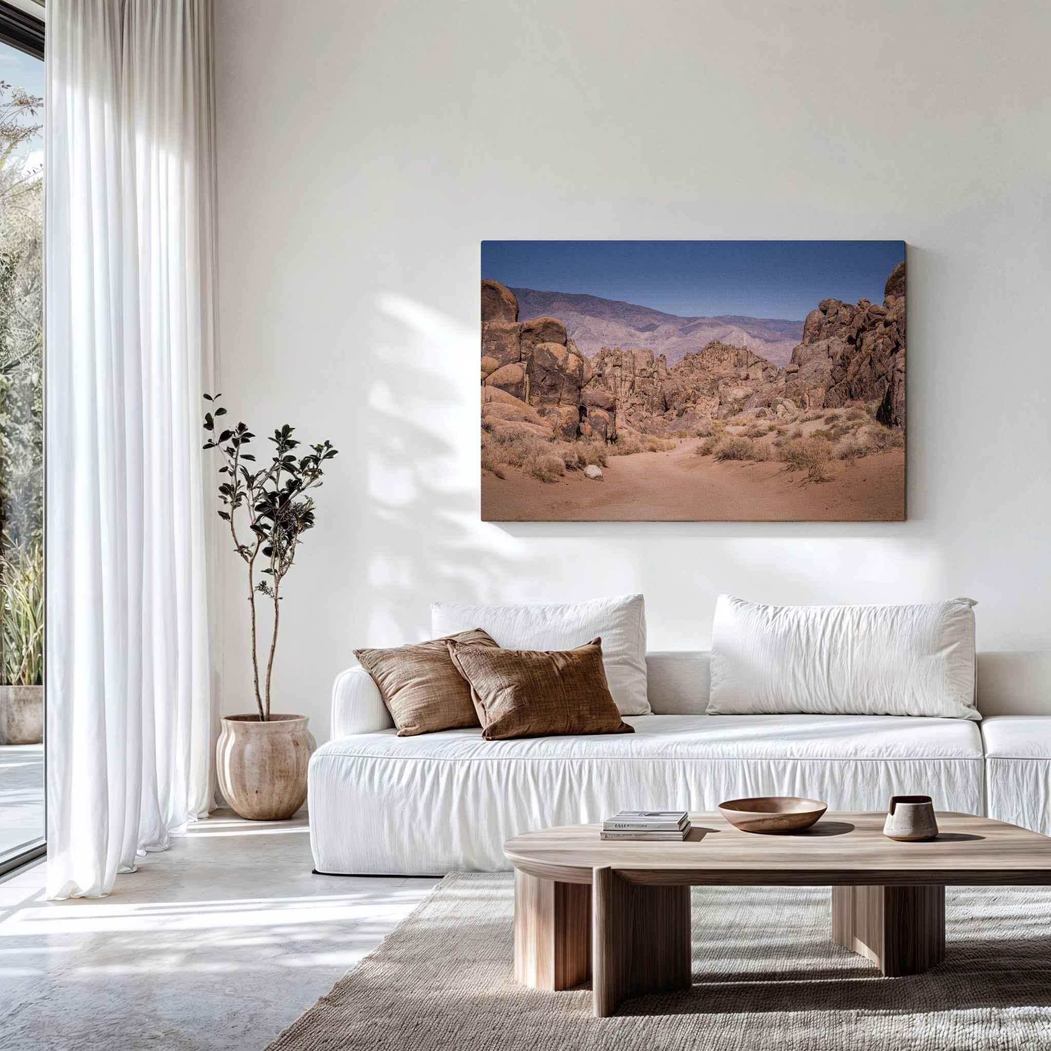 Sierra Desert Passage canvas print featuring the Alabama Hills near Lone Pine, California, displayed above a white sofa in a bright neutral living room.