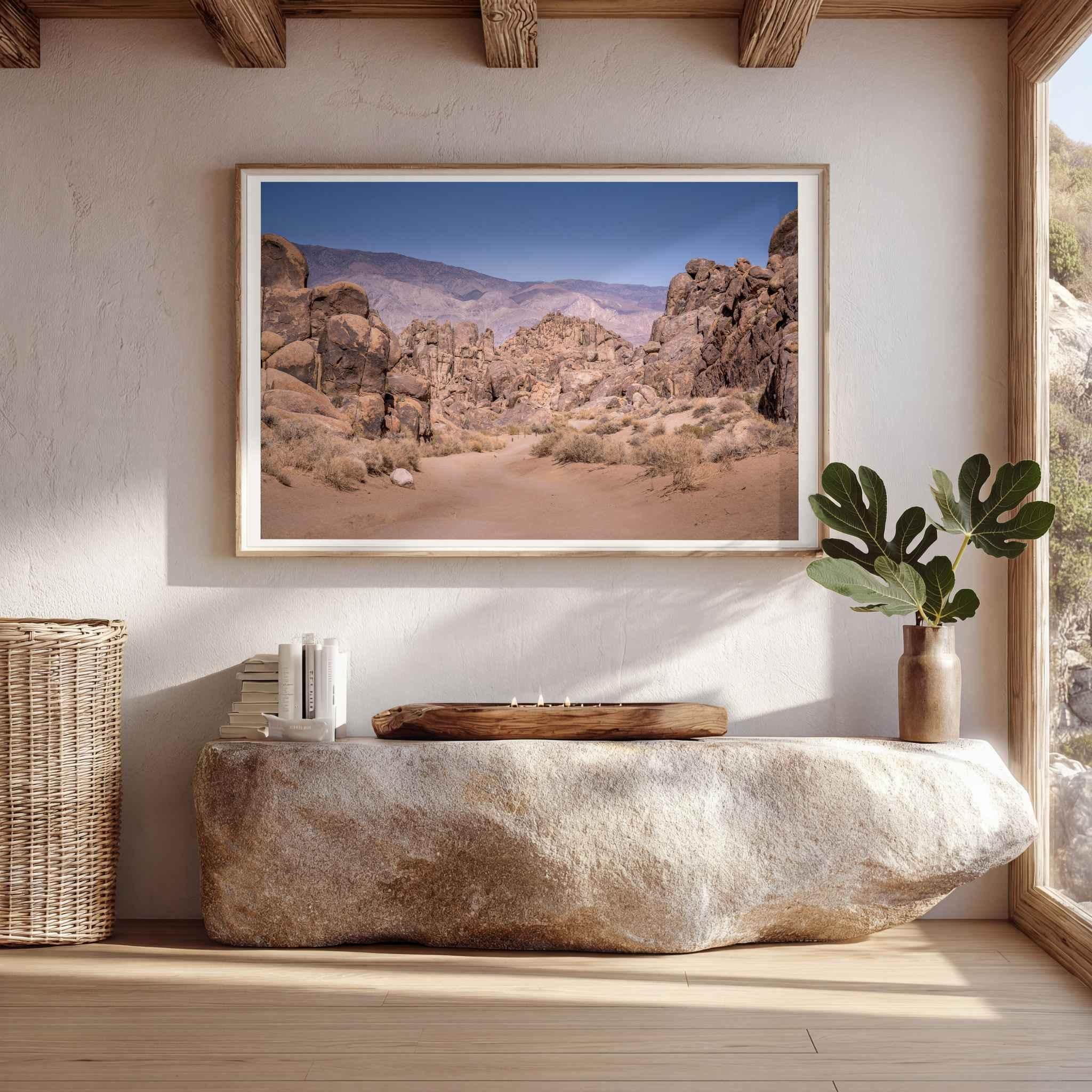Sierra Desert Passage landscape photography from the Eastern Sierra, California, displayed in a natural wood frame above a cream sofa in a warm neutral living room.