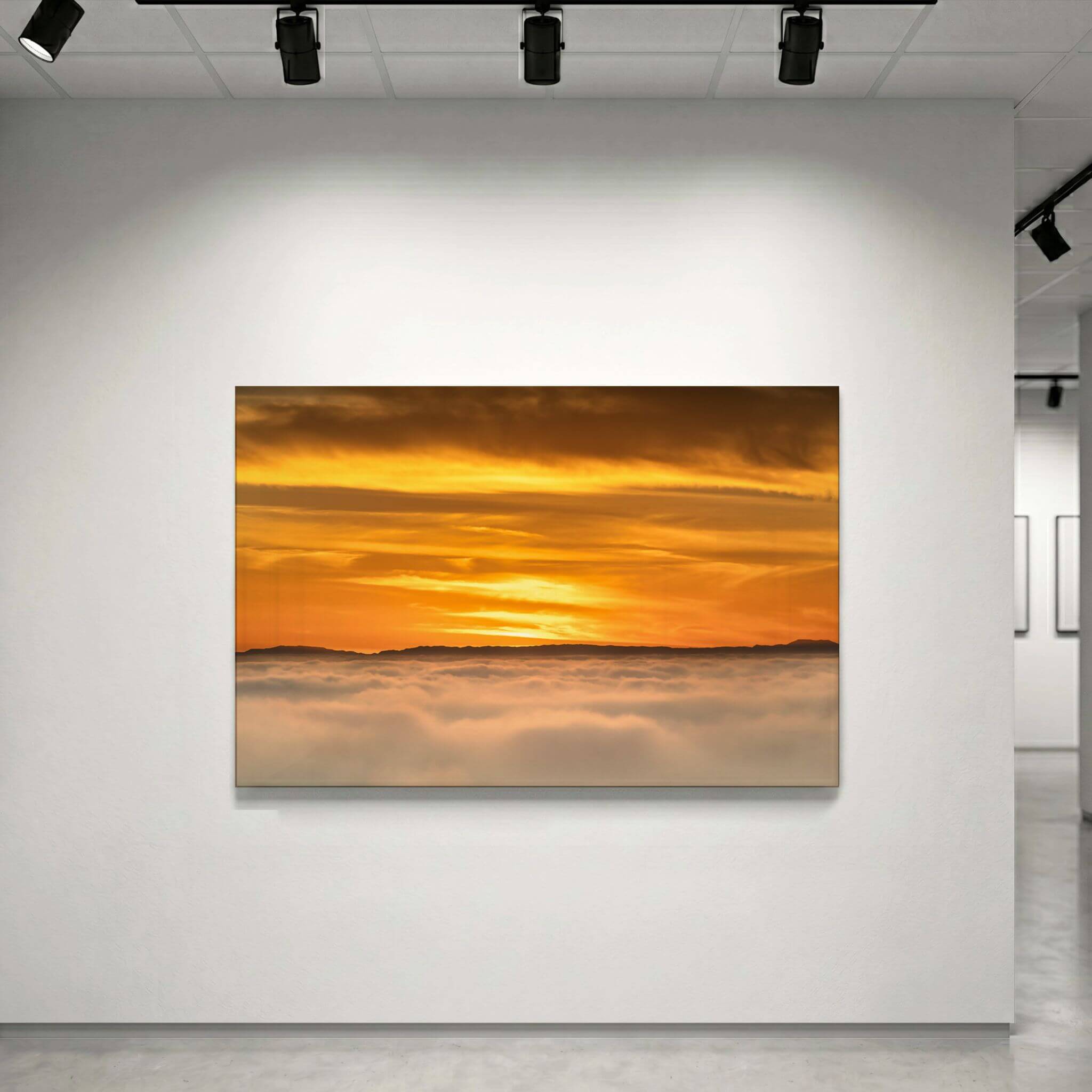 Gallery-style high-definition metal print of Soaring Above the Clouds by Abigail Diane Photography displayed under professional lighting, featuring a luminous golden sunset over clouds with striking depth and vibrant color.