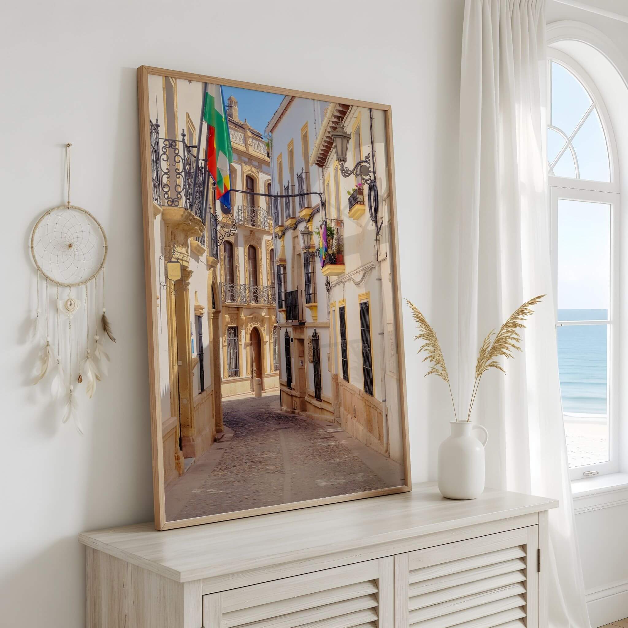 Streets of Ronda framed fine art print displayed in a bright coastal-style interior, featuring a sunlit historic street in Ronda, Spain – Abigail Diane Photography
