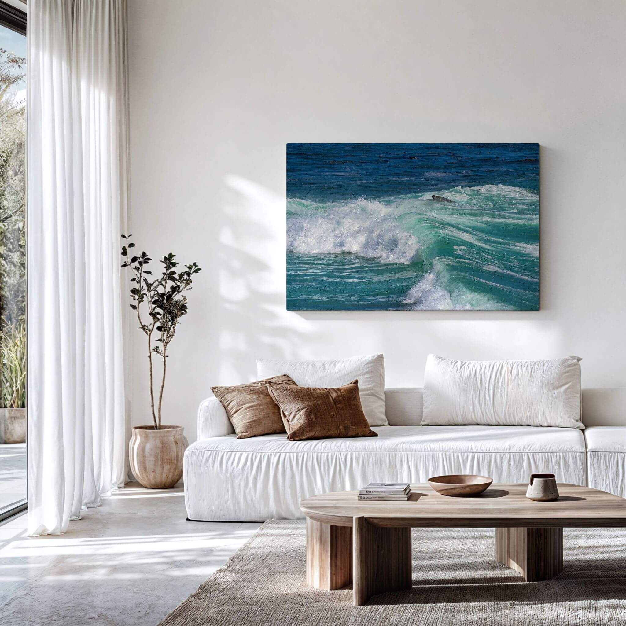 Turquoise Healing Waves canvas print displayed above a modern white sofa, showcasing vibrant turquoise surf rolling through the Pacific Ocean at Laguna Beach, California. Peaceful coastal photography by Abigail Diane Photography.