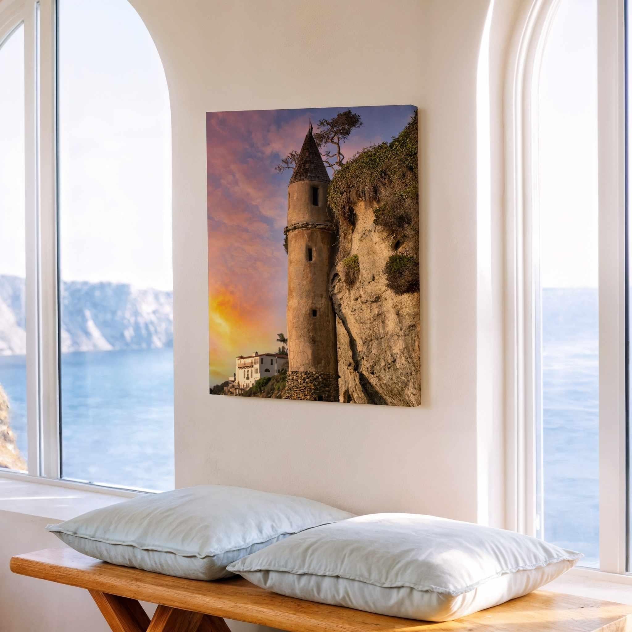Gallery wrapped canvas print featuring Victoria Beach Pirate Tower at sunset in Laguna Beach, California, displayed beside large coastal windows with ocean views, creating a bright and relaxing seaside interior.