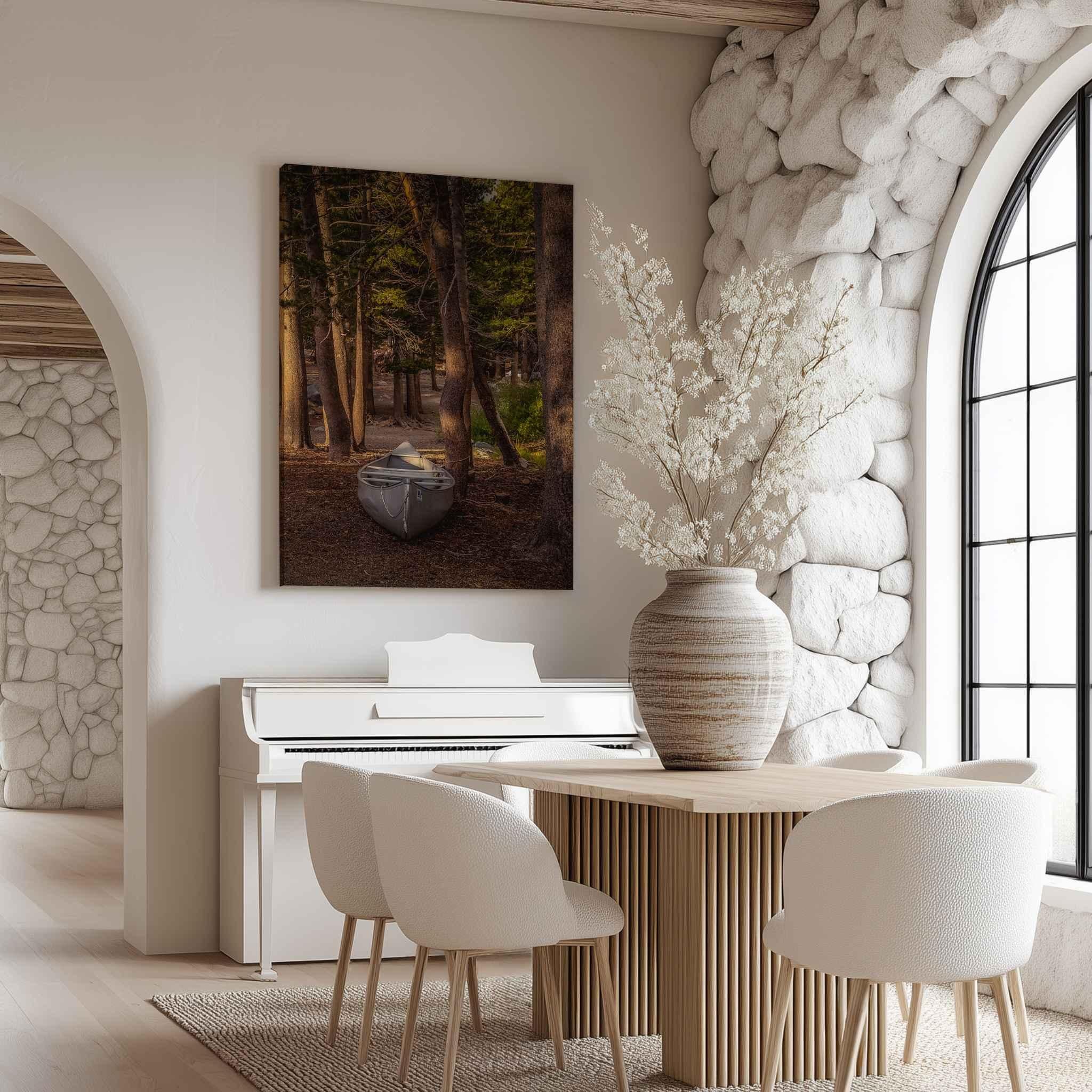 Waiting for the Water canvas print featuring a canoe among the pines in Mammoth Lakes, California, displayed in a light rustic dining room.
