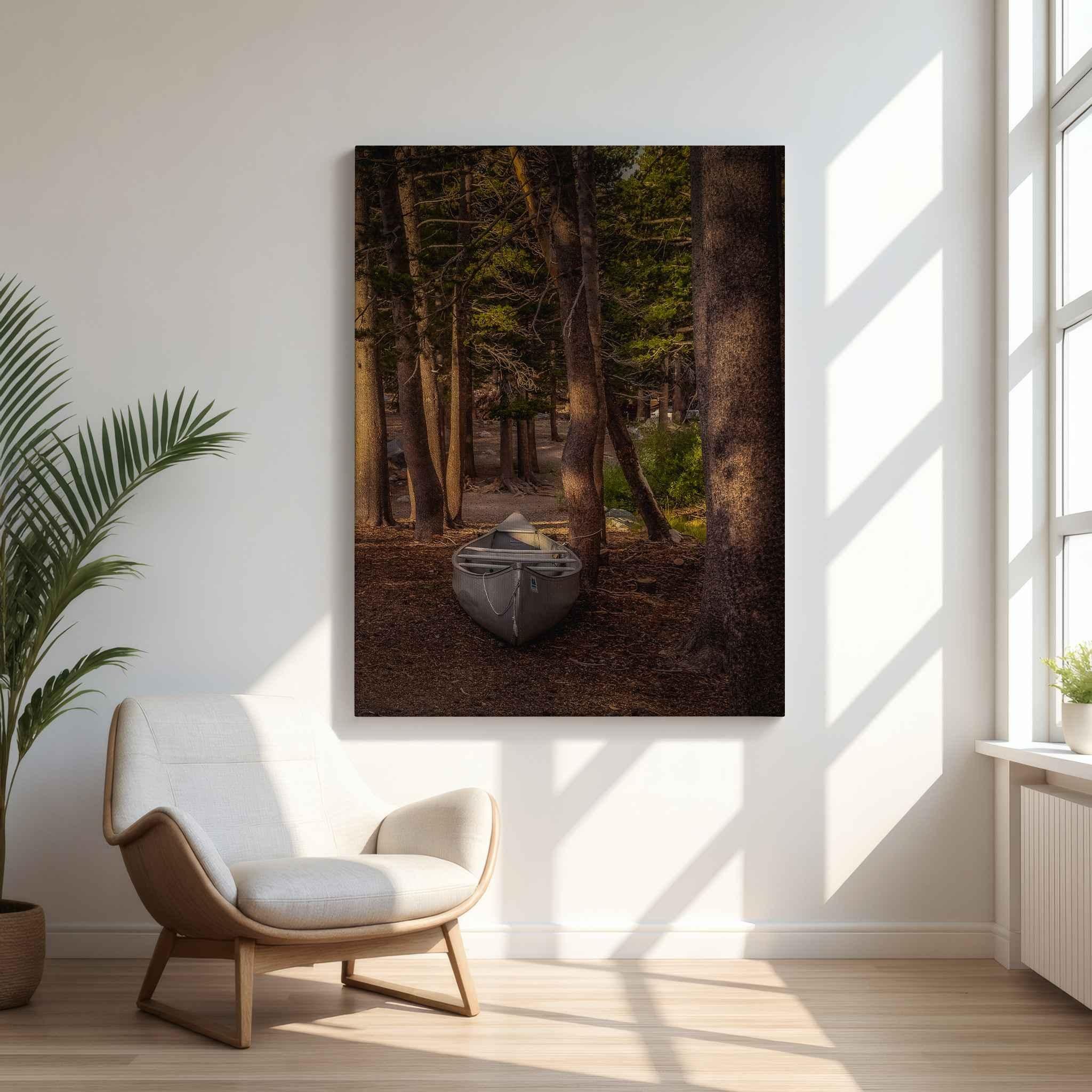 Waiting for the Water canvas print featuring a canoe resting among pine trees in Mammoth Lakes, California, displayed in a bright modern reading nook.