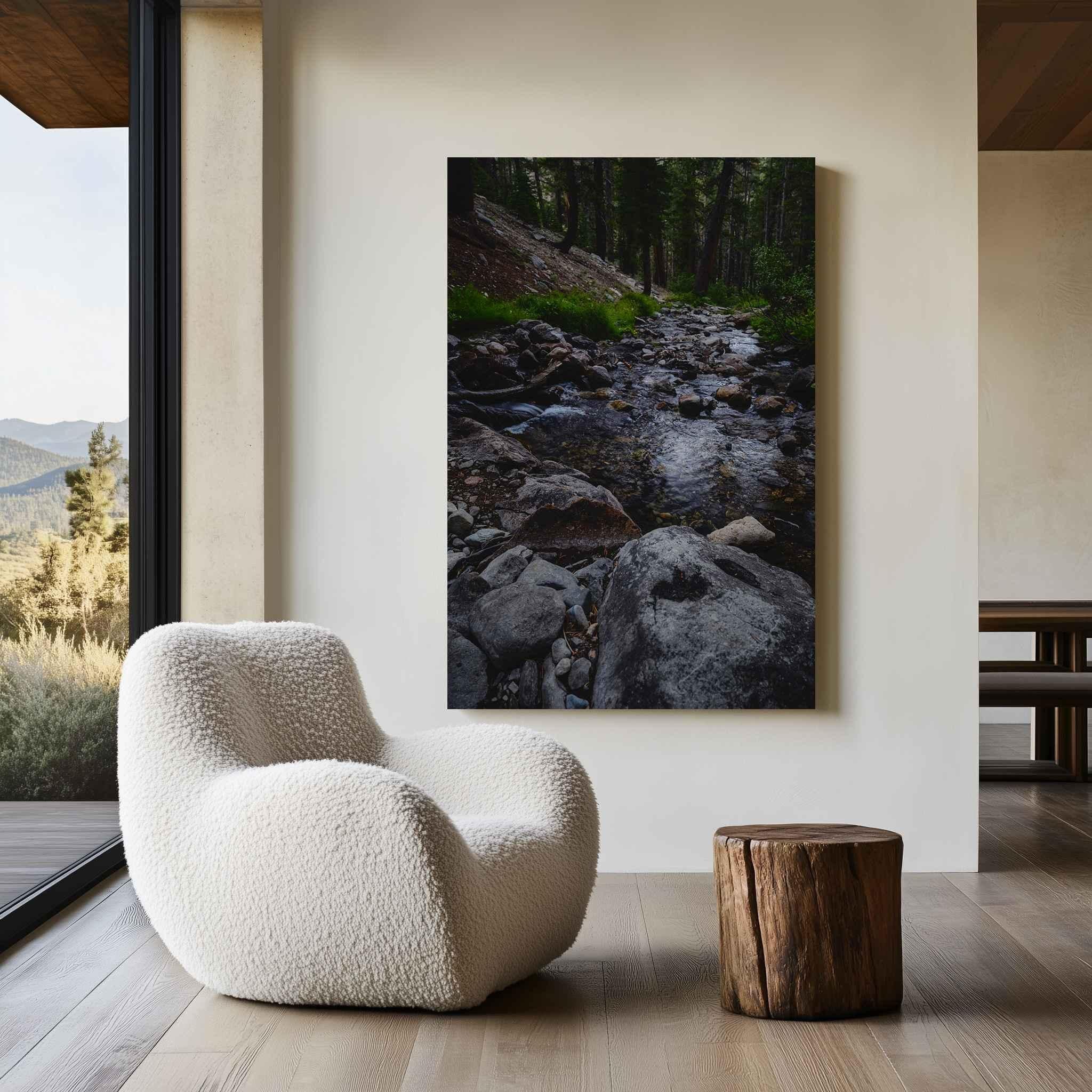 Where Stepping Stones Lead metal print displayed above a rustic wood bench, featuring a rocky mountain stream flowing through the forest in California’s Eastern Sierra.