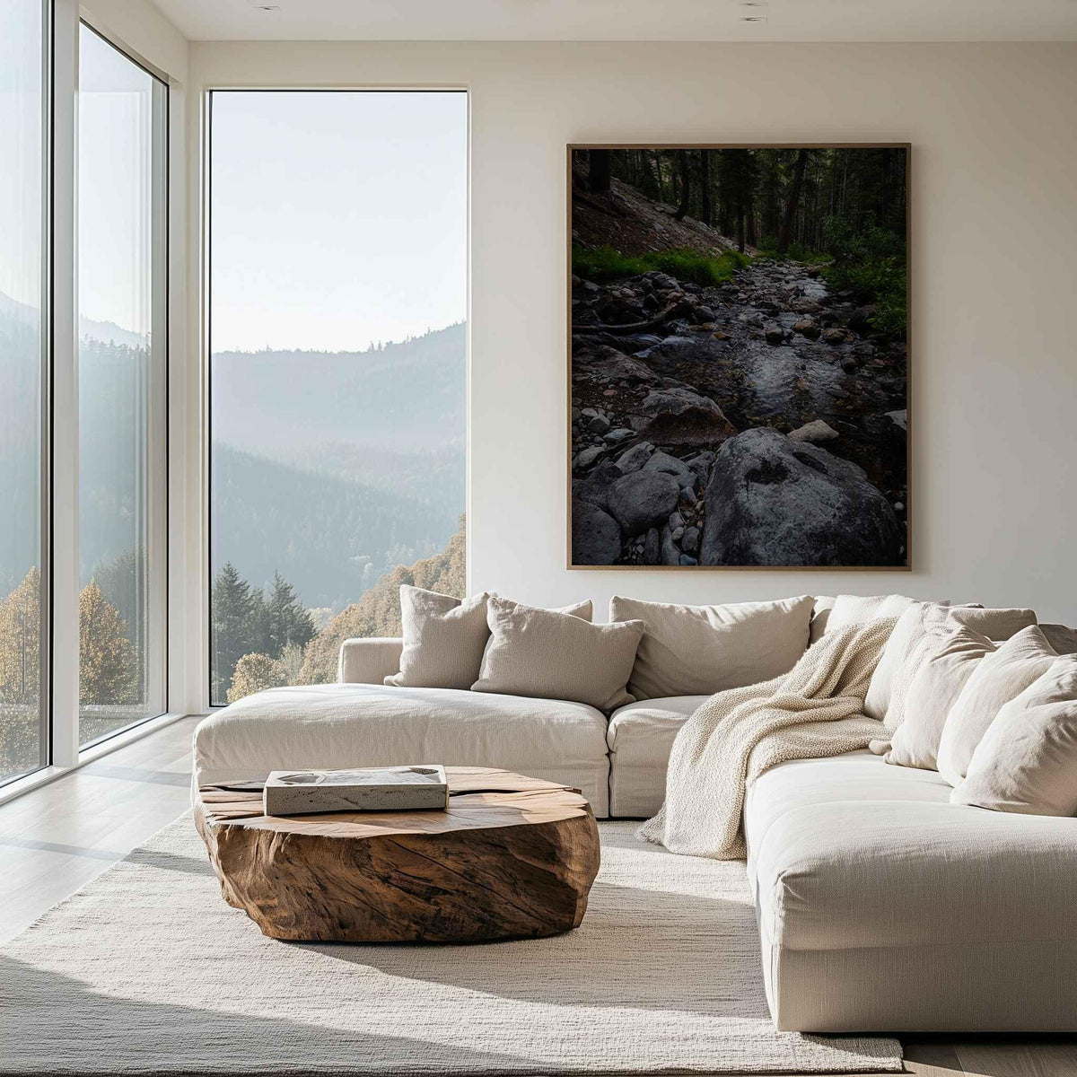 Where the Stepping Stones Lead fine art print displayed in a natural wood frame above a white sofa in a modern living room, featuring a rocky forest stream in California’s Eastern Sierras.