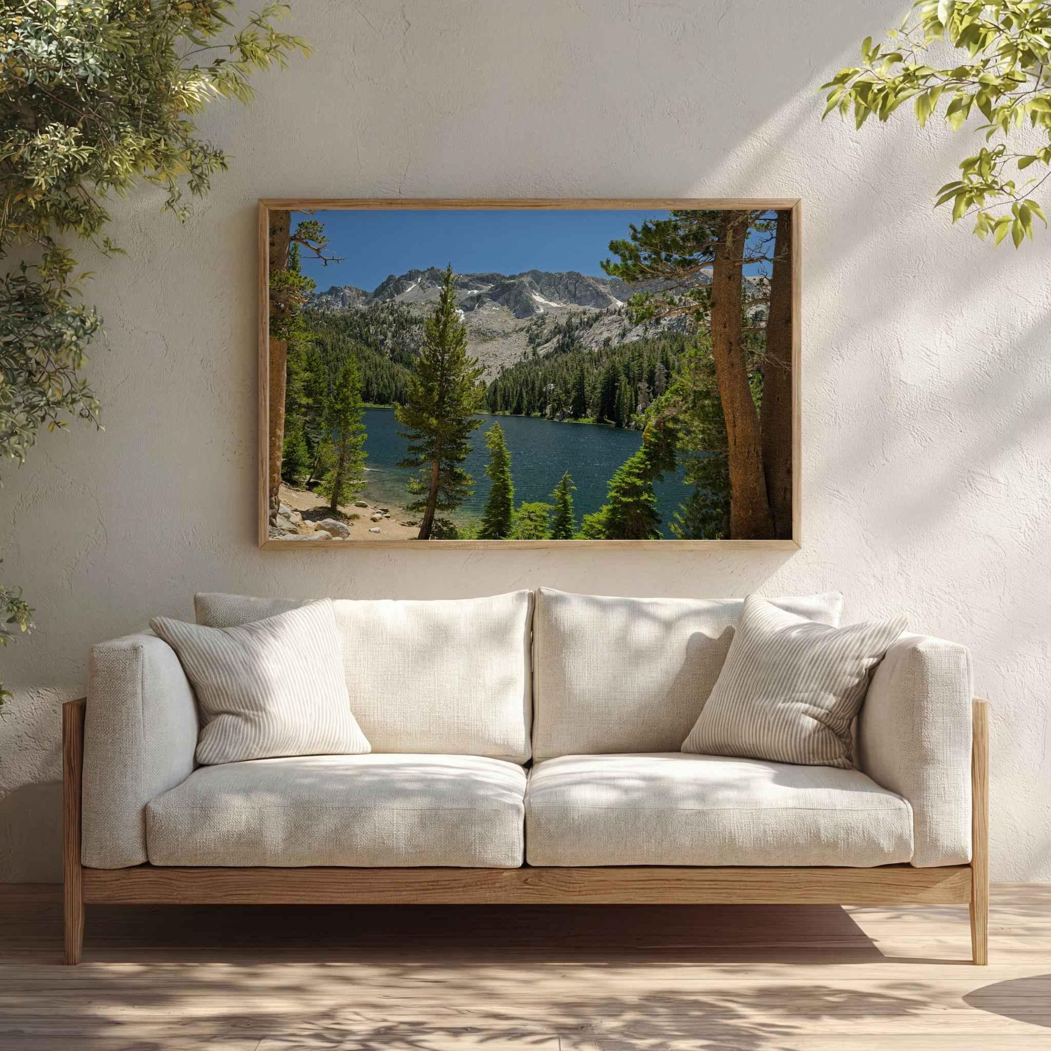 Where the Trail Gives Way to Still Waters metal print displayed above a white sectional, featuring an alpine lake and Sierra Nevada mountains near Mammoth Lakes, California.