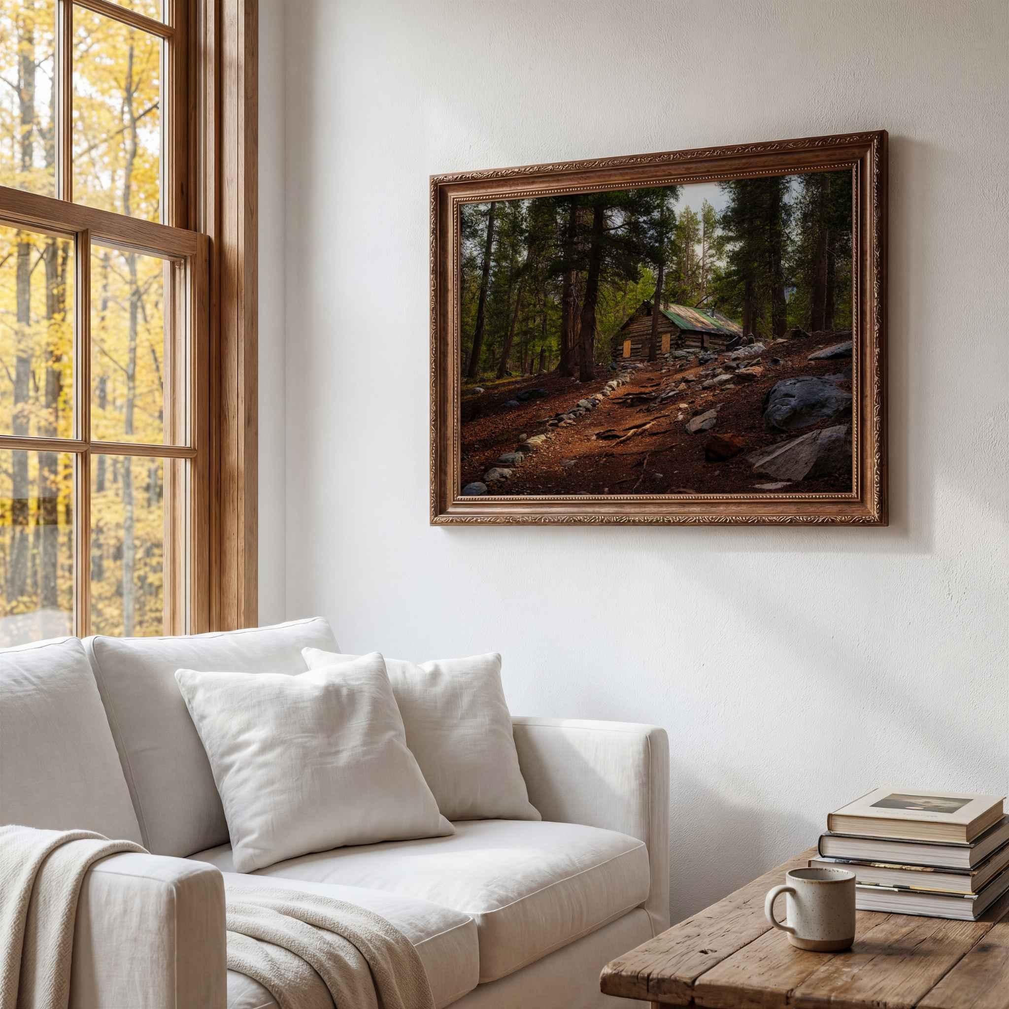 Where the Trail Meets the Past fine art print featuring historic Mahan Cabin near Mammoth Lakes in California’s Eastern Sierra, displayed in an ornate wood frame in a warm, rustic living room.