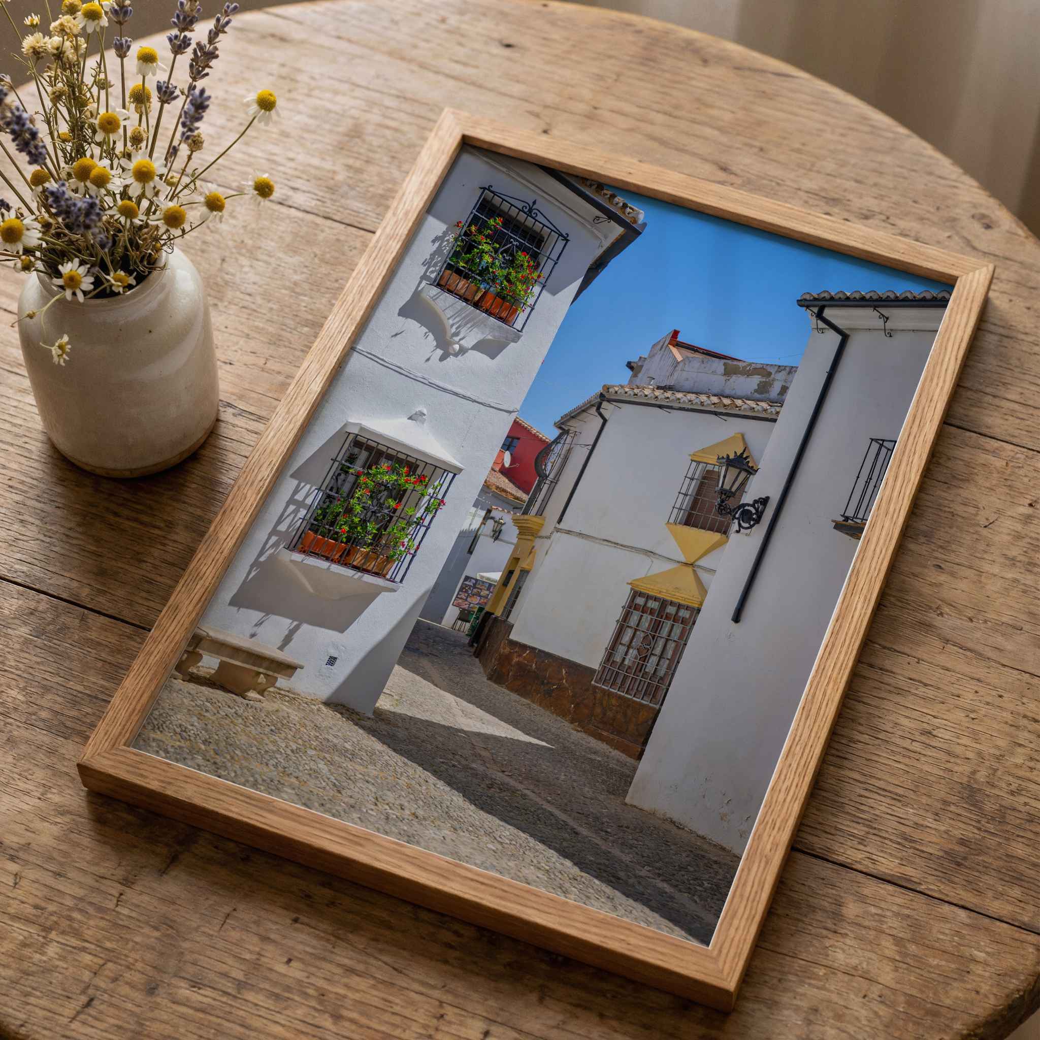 Whitewashed Streets of Setenil fine art print featuring whitewashed houses and flower-filled windows in Setenil de las Bodegas, Spain – Abigail Diane Photography